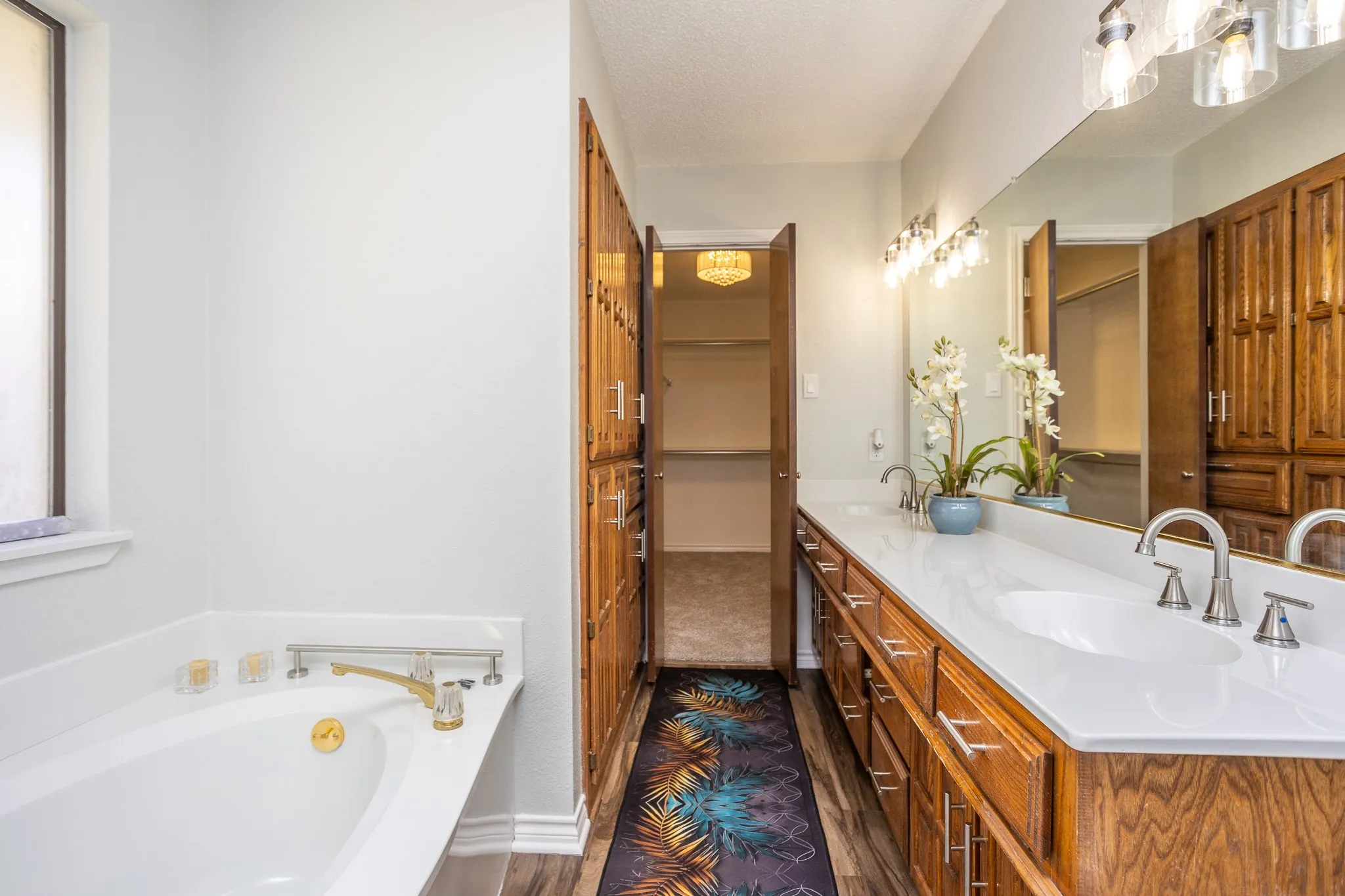 DOBLE SINK, MAN MADE MARBLE IN LIKE NEW CONDTON, STORAGE CABINETS ON LEFT AND WALK IN CLOSET