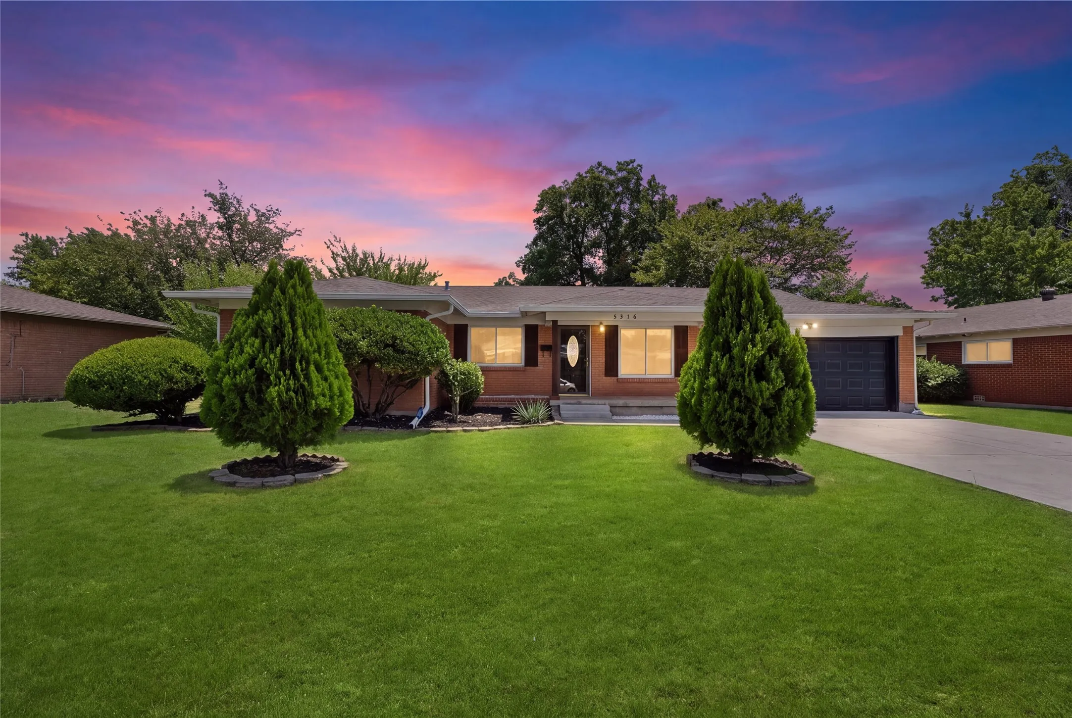Brick exterior with a single-car garage and a concrete driveway