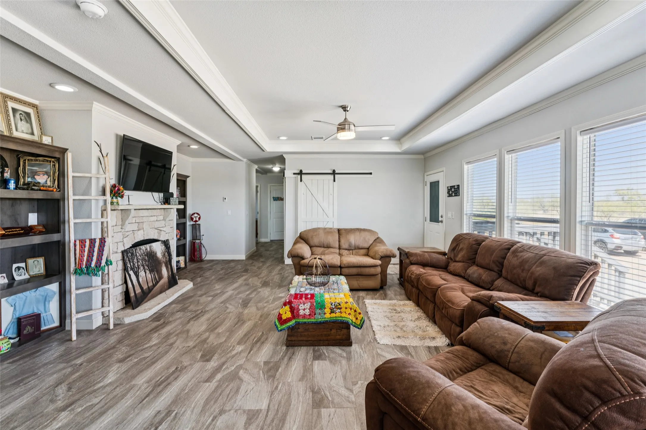 Recessed lighting, vinyl plank flooring, coffered ceiling, and multiple windows for natural lighting