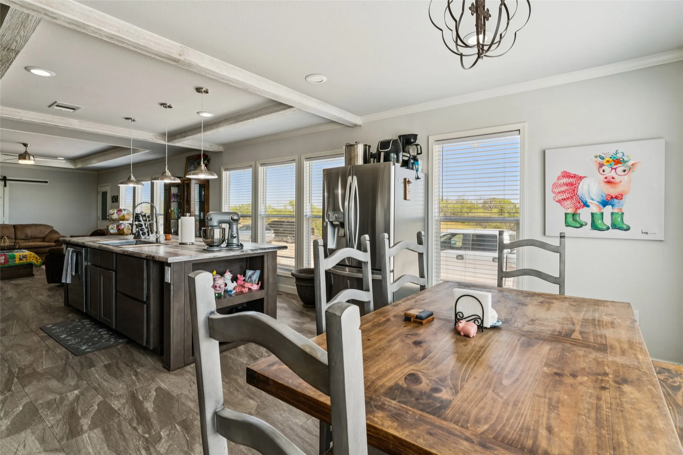Kitchen featuring a large island with dark wood-finish cabinetry, recessed lighting, and pendant lights
