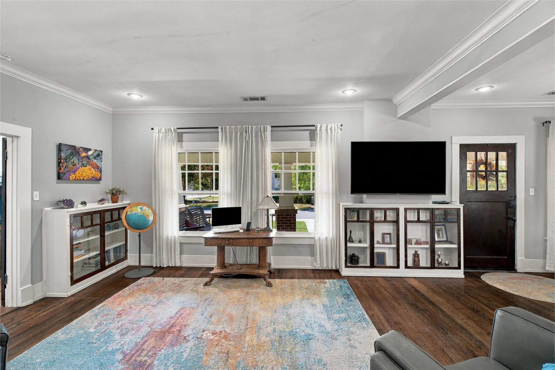 The large front windows look over the shaded front porch.