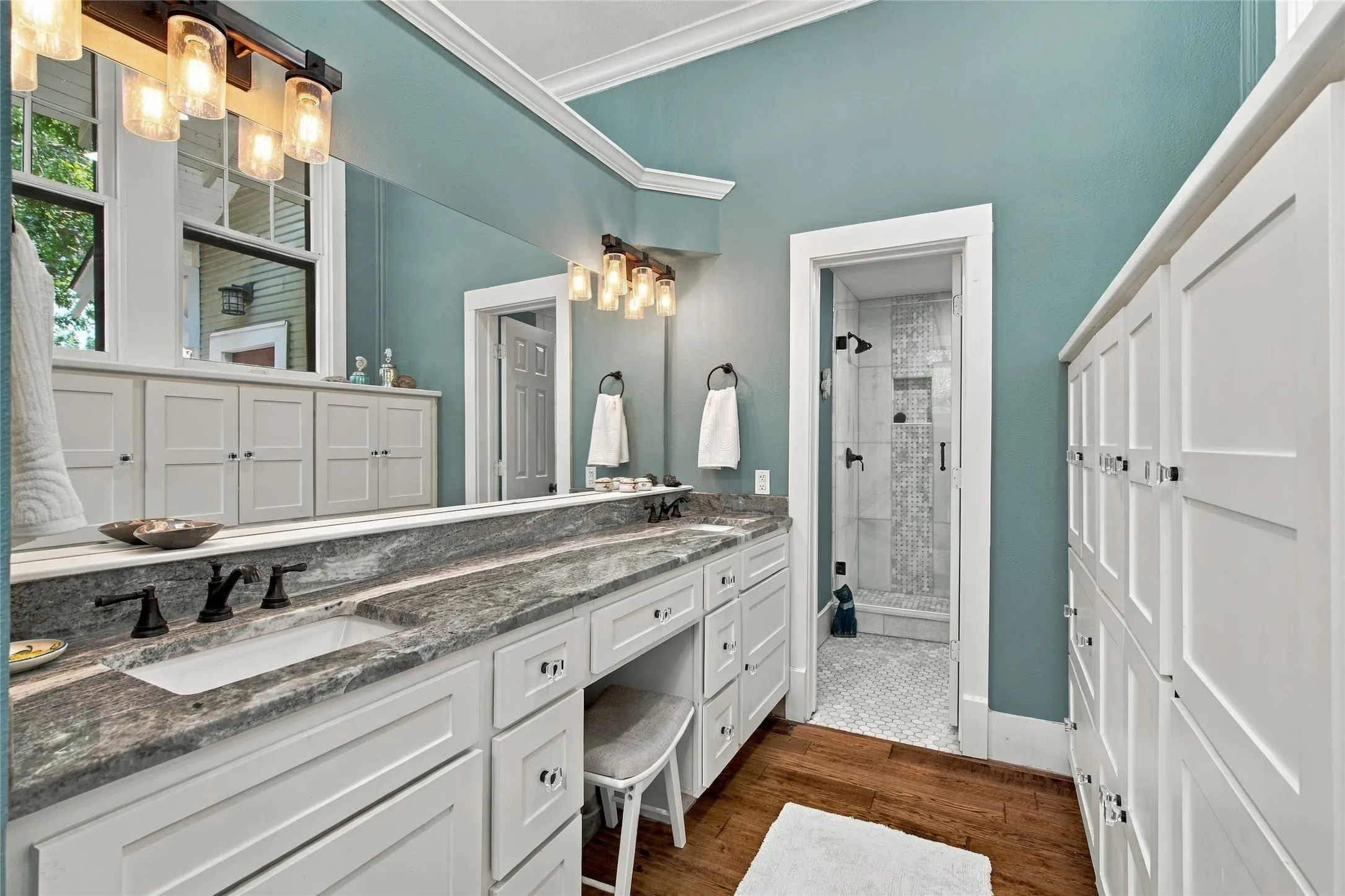 Dual vanity with a stone countertop and undermount sinks