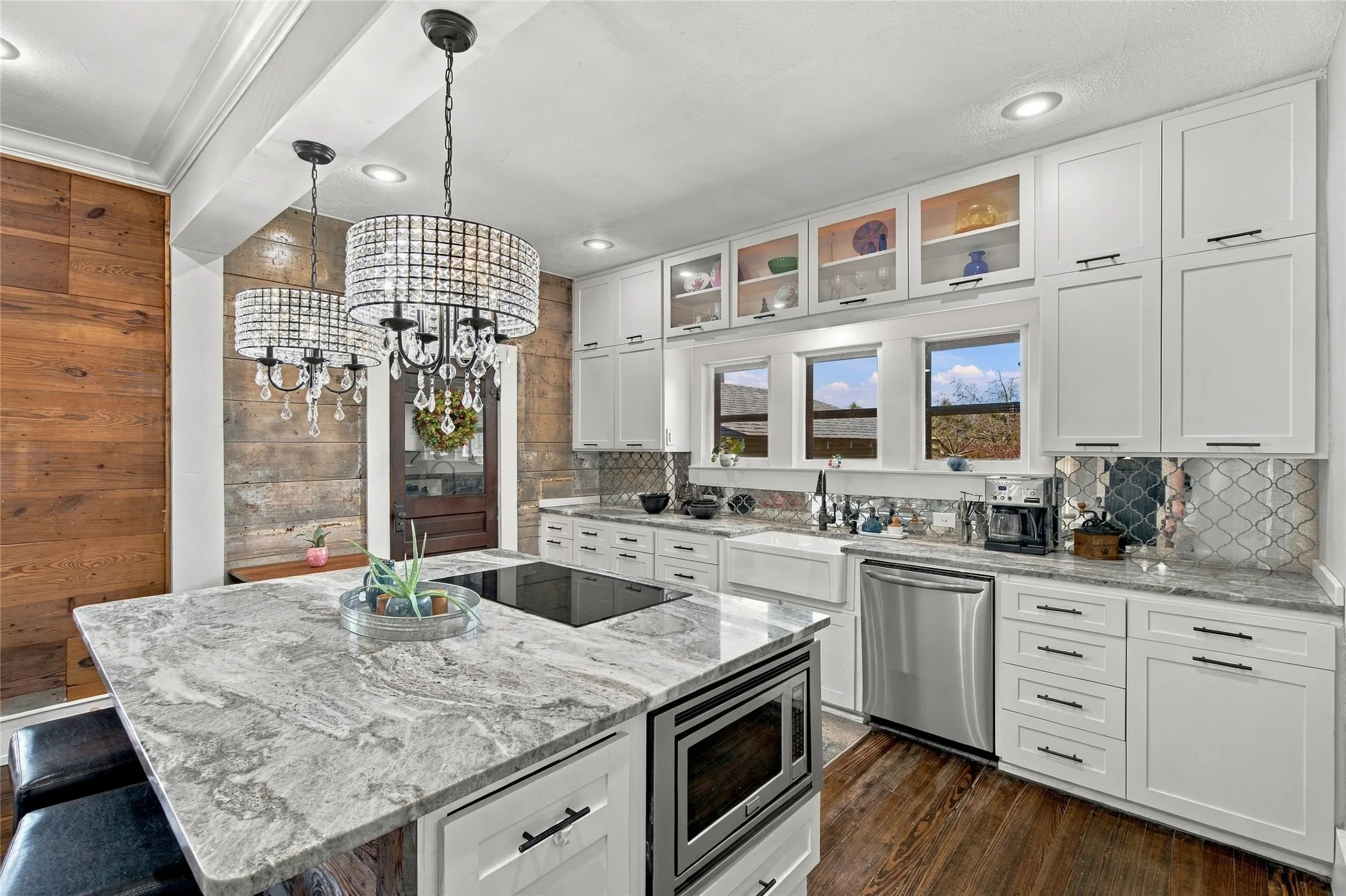 The island features an integrated cooktop, a microwave and a convection oven on the other side.