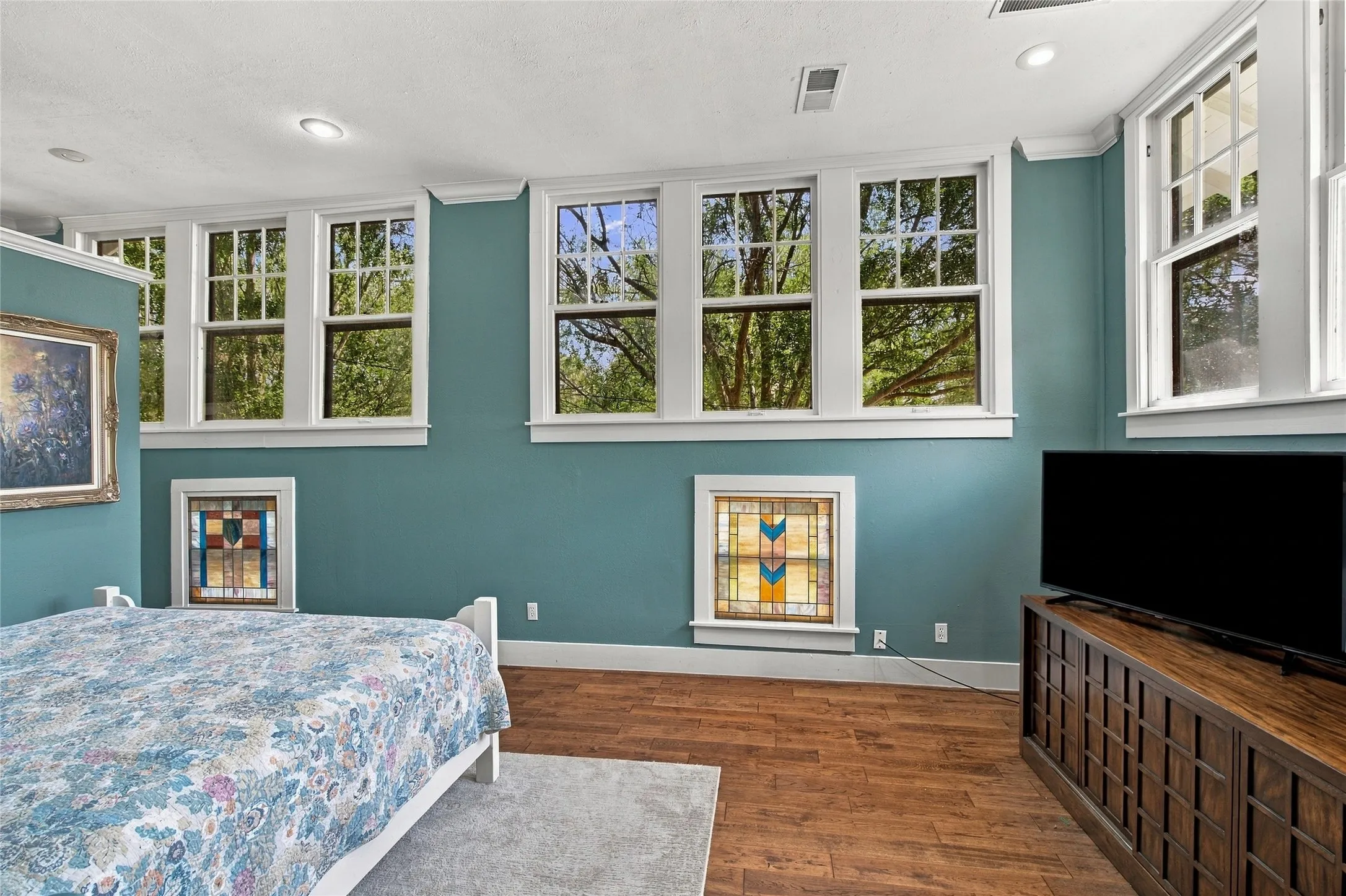 Engineered wood flooring and walls of windows create a warm, sunny room for relaxation.