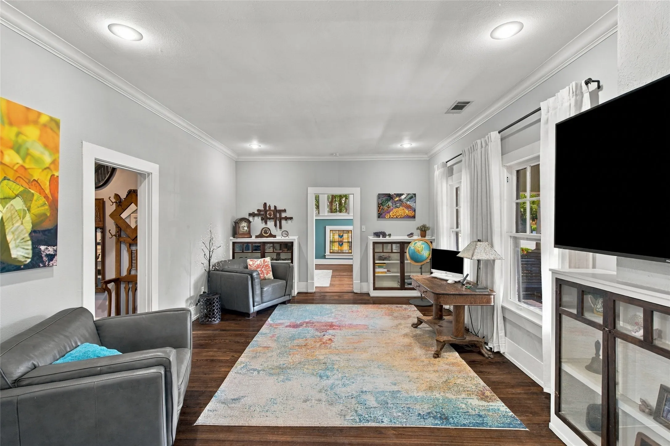 The far wall has 2 original built-in cabinets flanking the door to the primary suite.