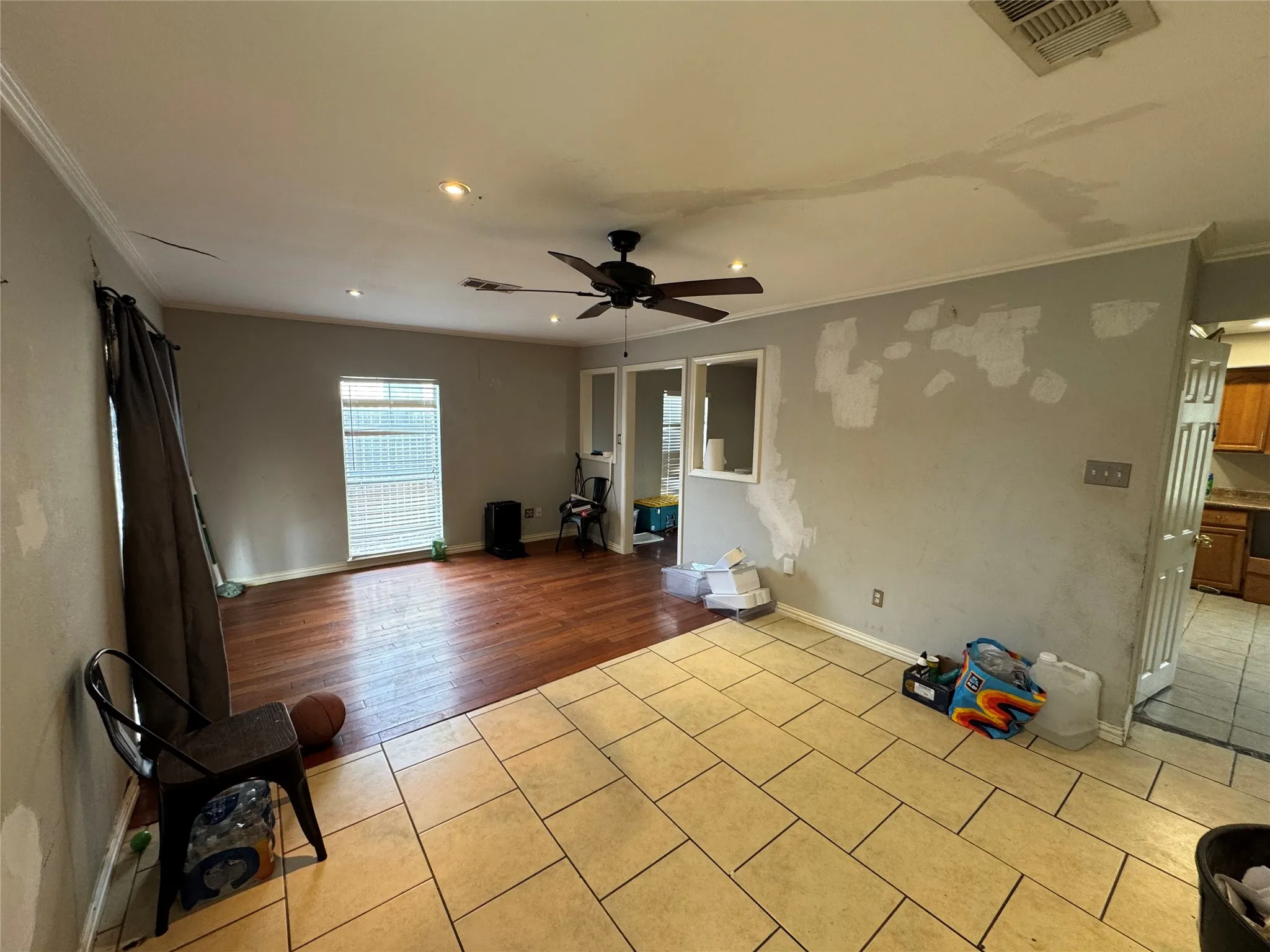 Recessed lighting, ceiling fan, crown molding, wood-finish flooring, and tile flooring