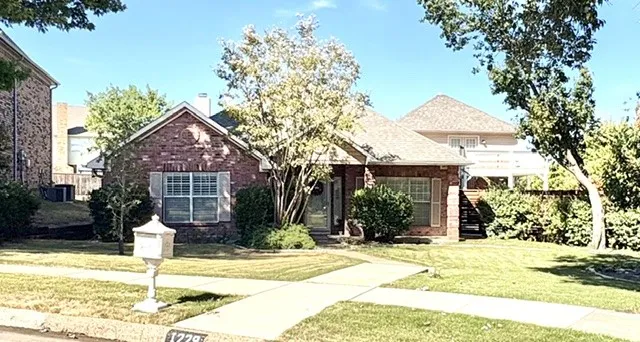 Brick exterior with white window shutters