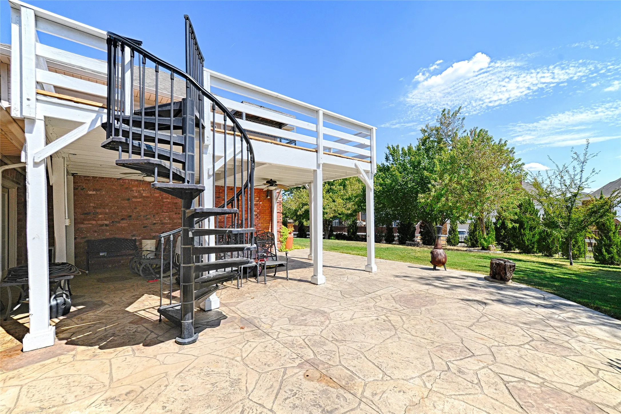Expansive stamped concrete patio with direct access to a covered outdoor area
