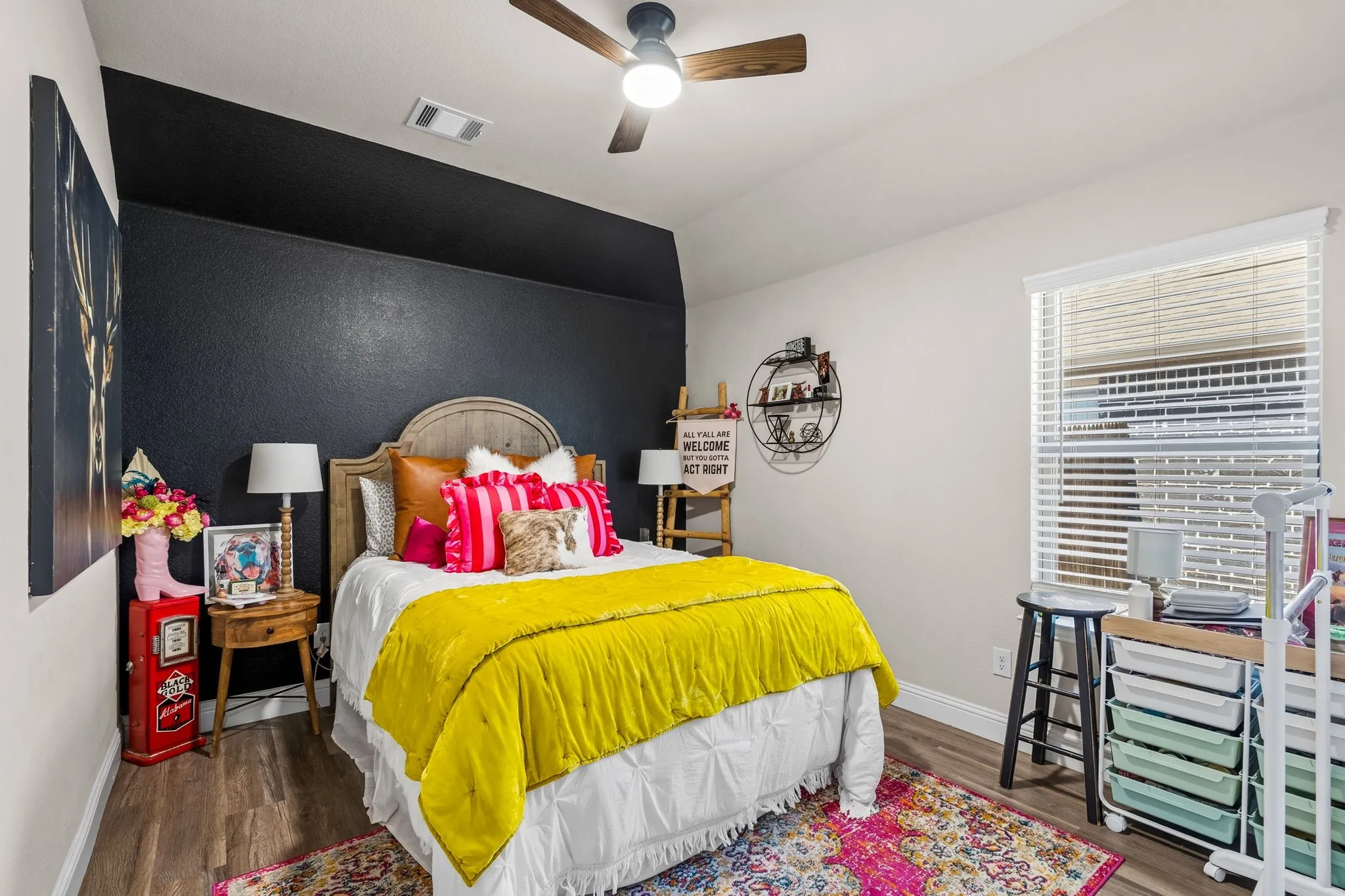 Wood-finish flooring, ceiling fan with integrated lighting, window with blinds, and white trim