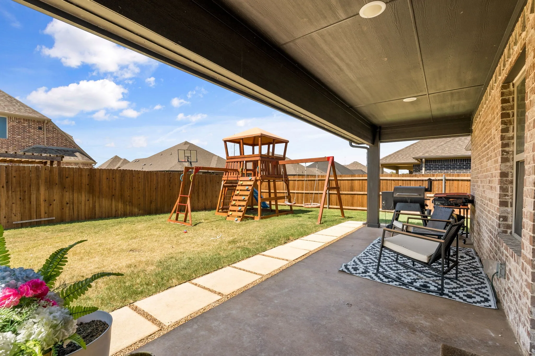 Covered patio with recessed lighting, concrete flooring, and brick exterior