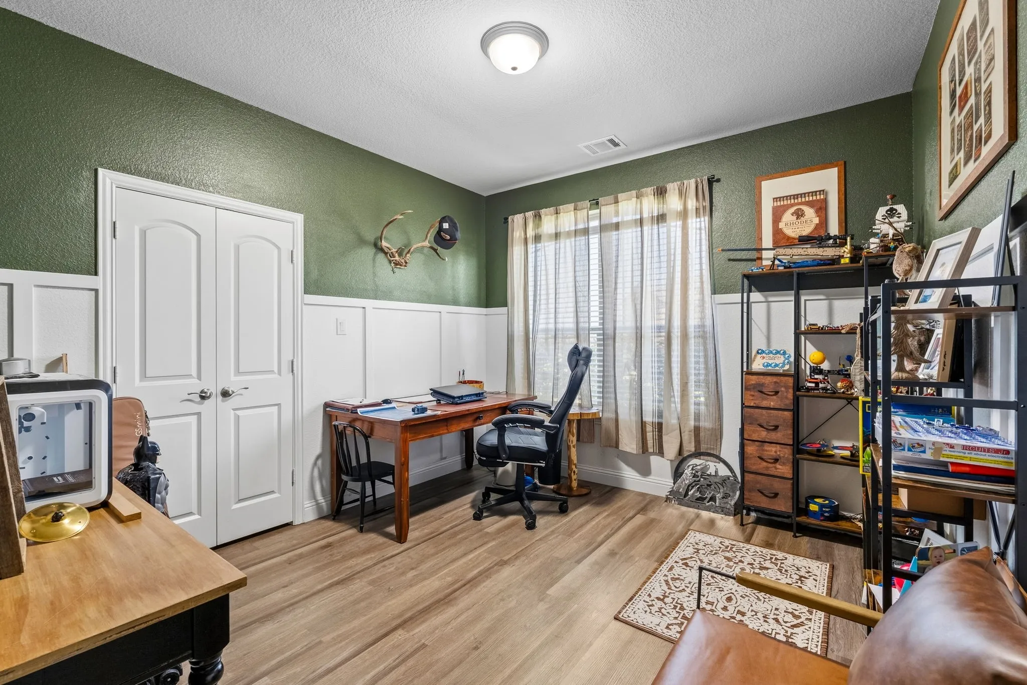 Wood-finish flooring, wainscoting, double-panel doors, and a ceiling light​​‌​​​​‌​​‌‌​‌‌​​​‌‌​‌​‌​‌​​​‌​​ fixture