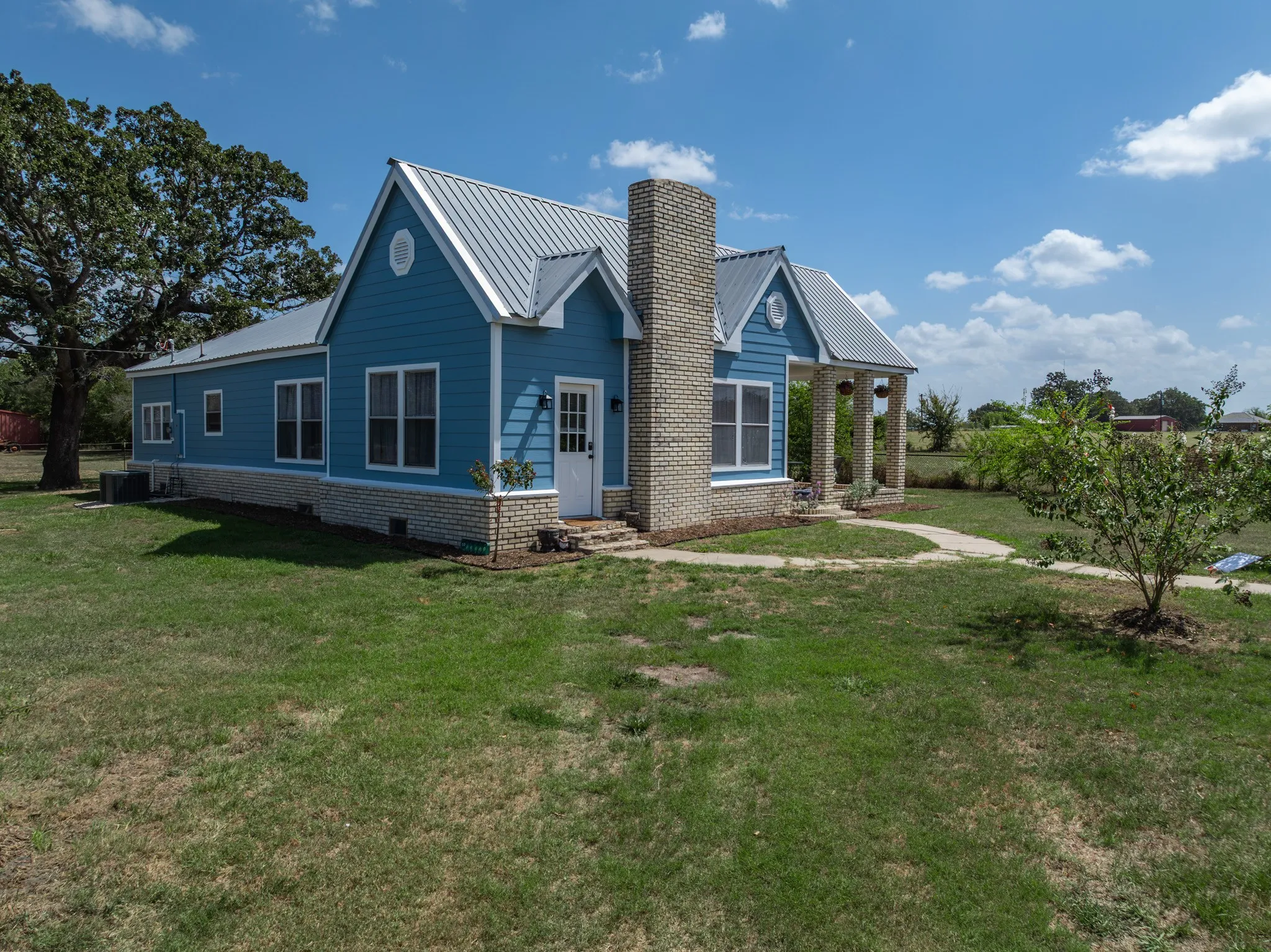 Blue siding exterior with a metal roof