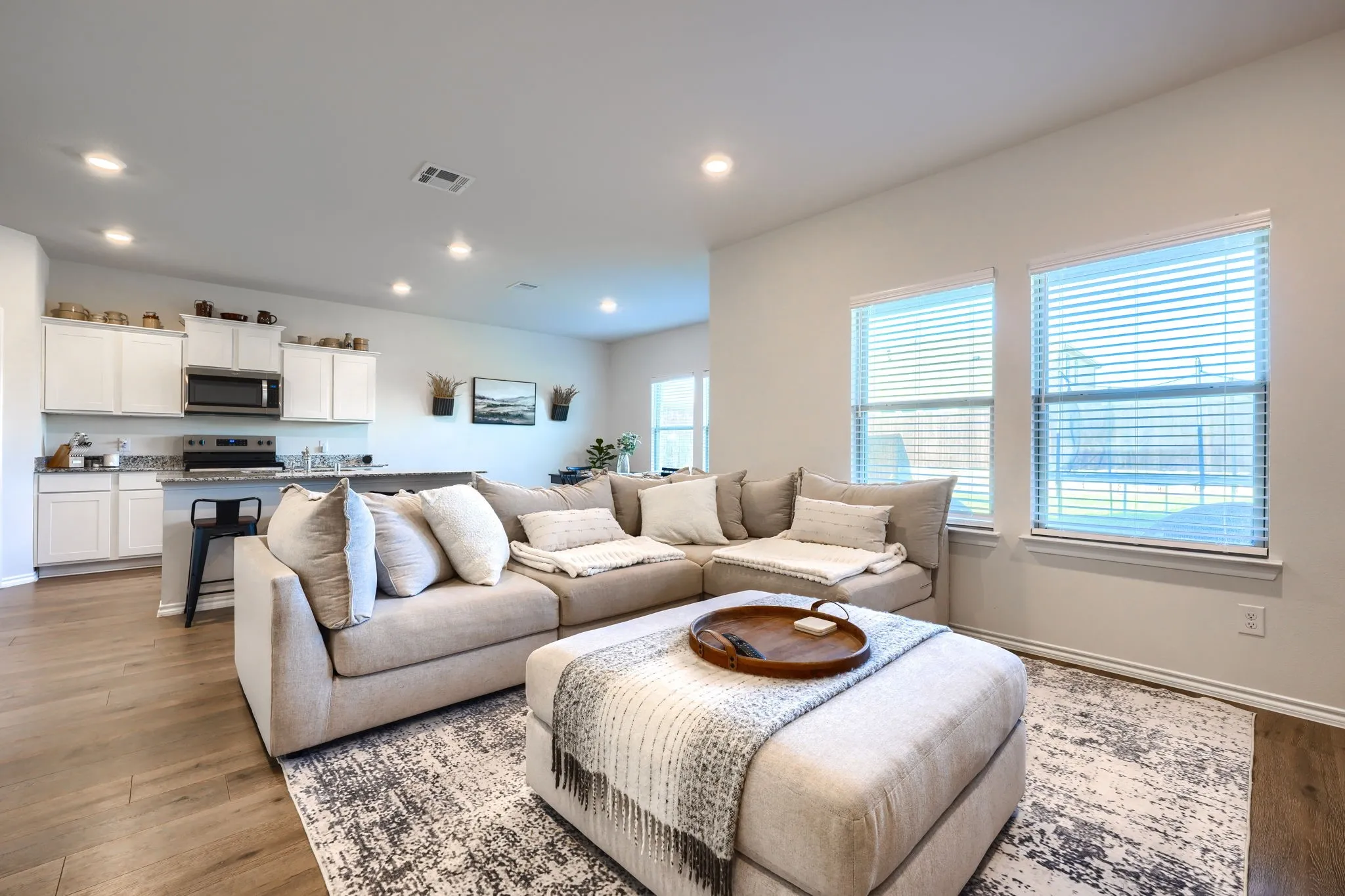 Recessed lighting illuminates the wood-finish flooring