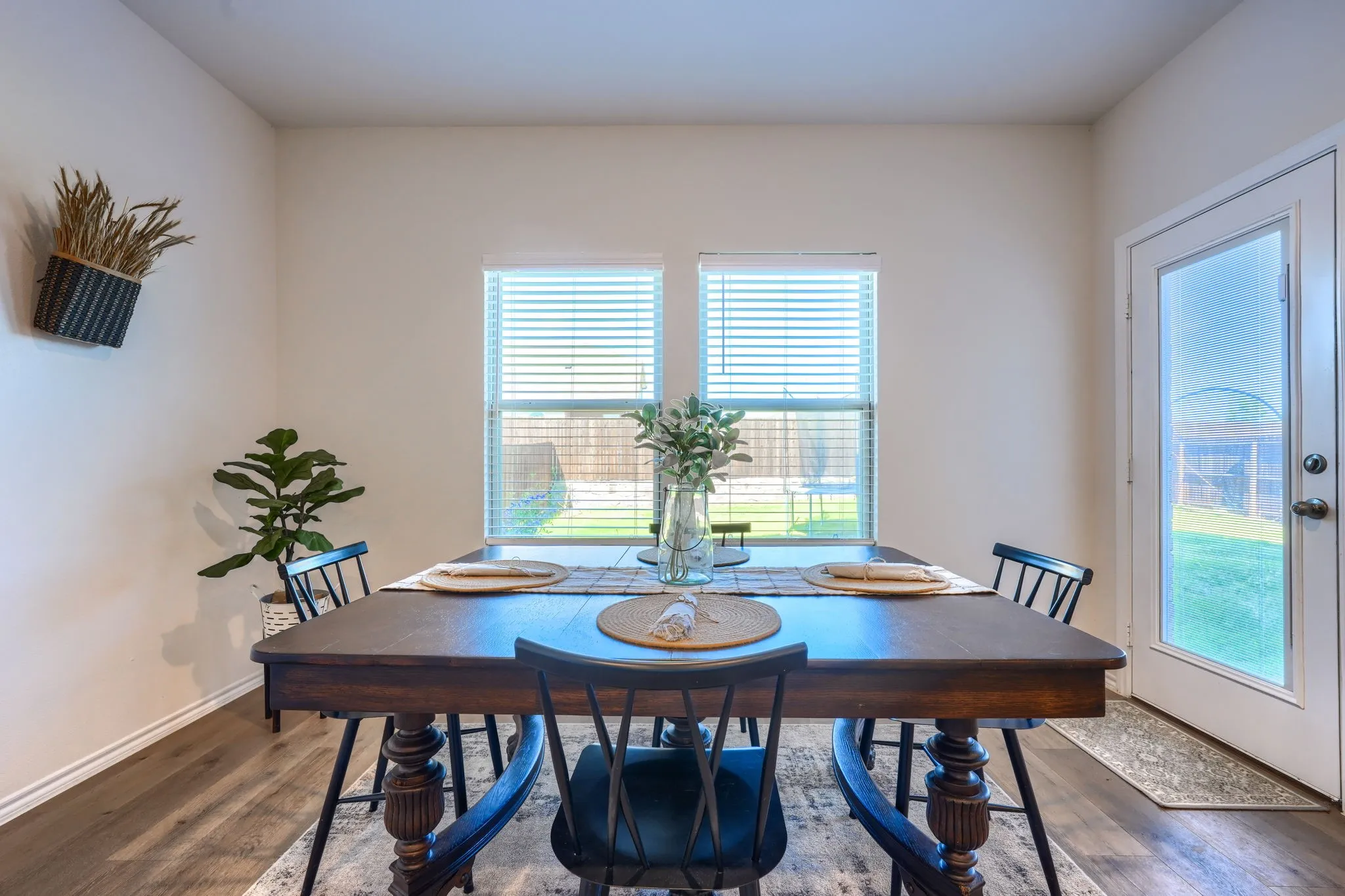 Wood-finish flooring, white walls, and a glass-paneled exterior door