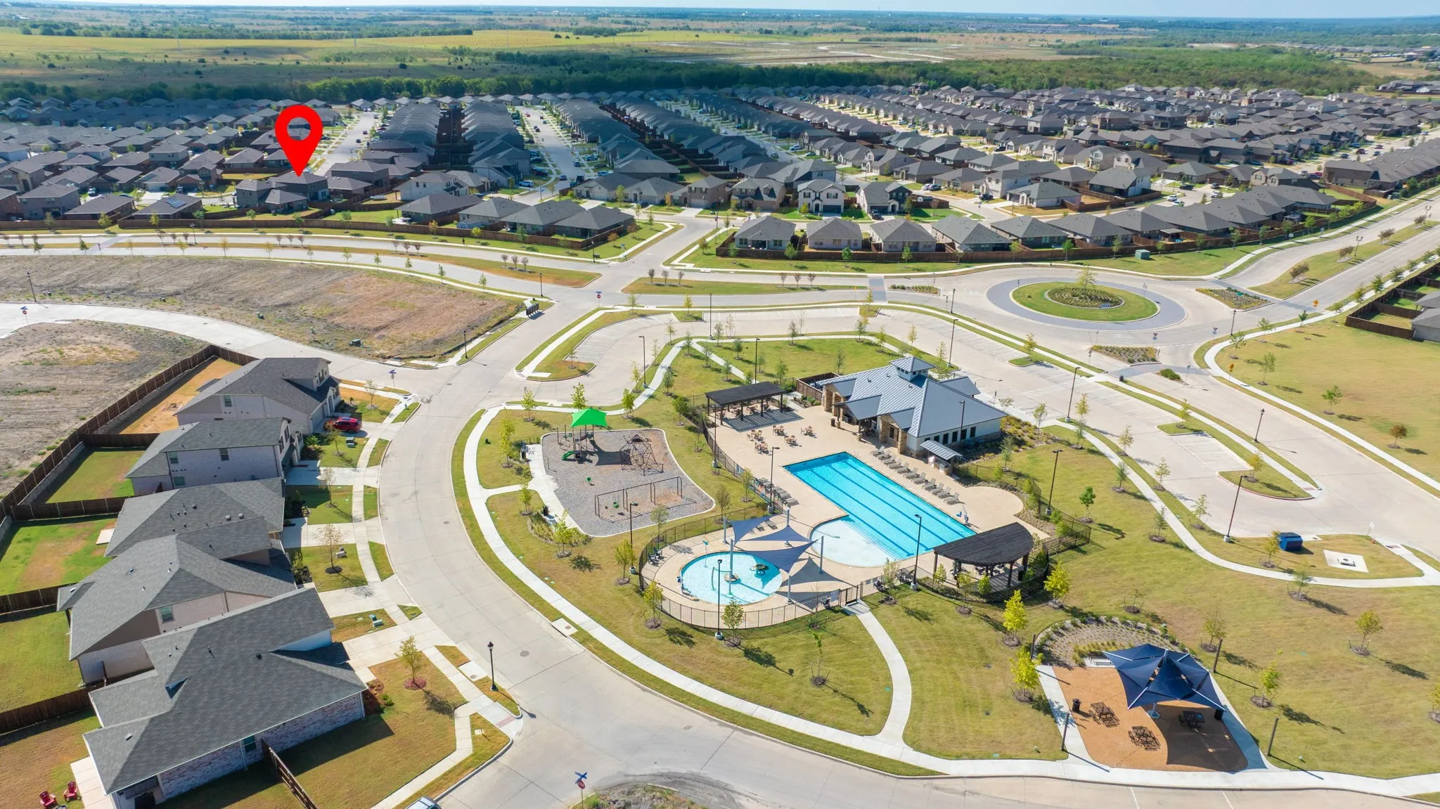 Expansive community featuring a large swimming pool, a dedicated children's play area, and a community clubhouse