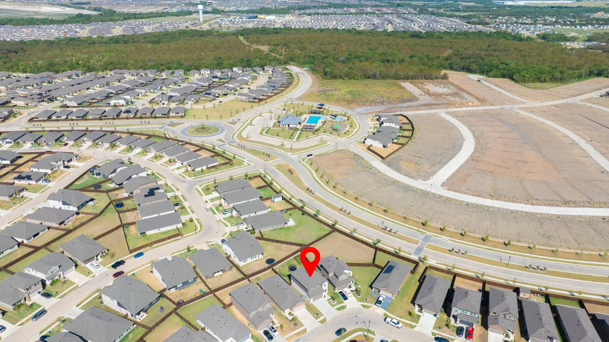 Newly developed community featuring a residential street grid and a central community pool