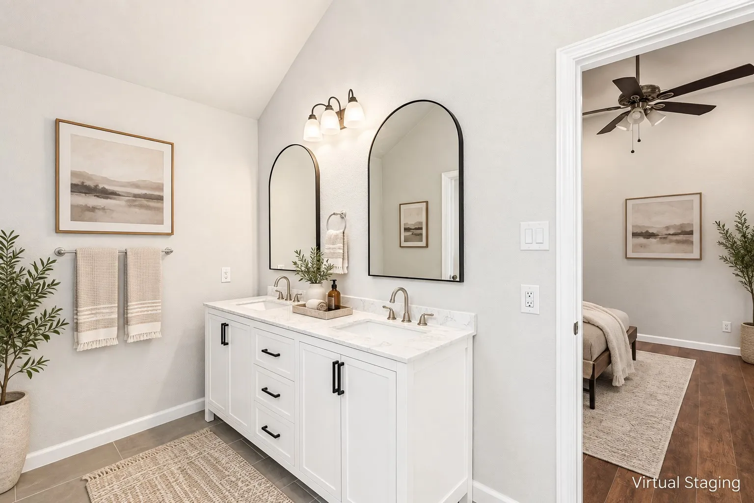 Dual vanity with white cabinetry, arched mirrors, and brushed nickel fixtures