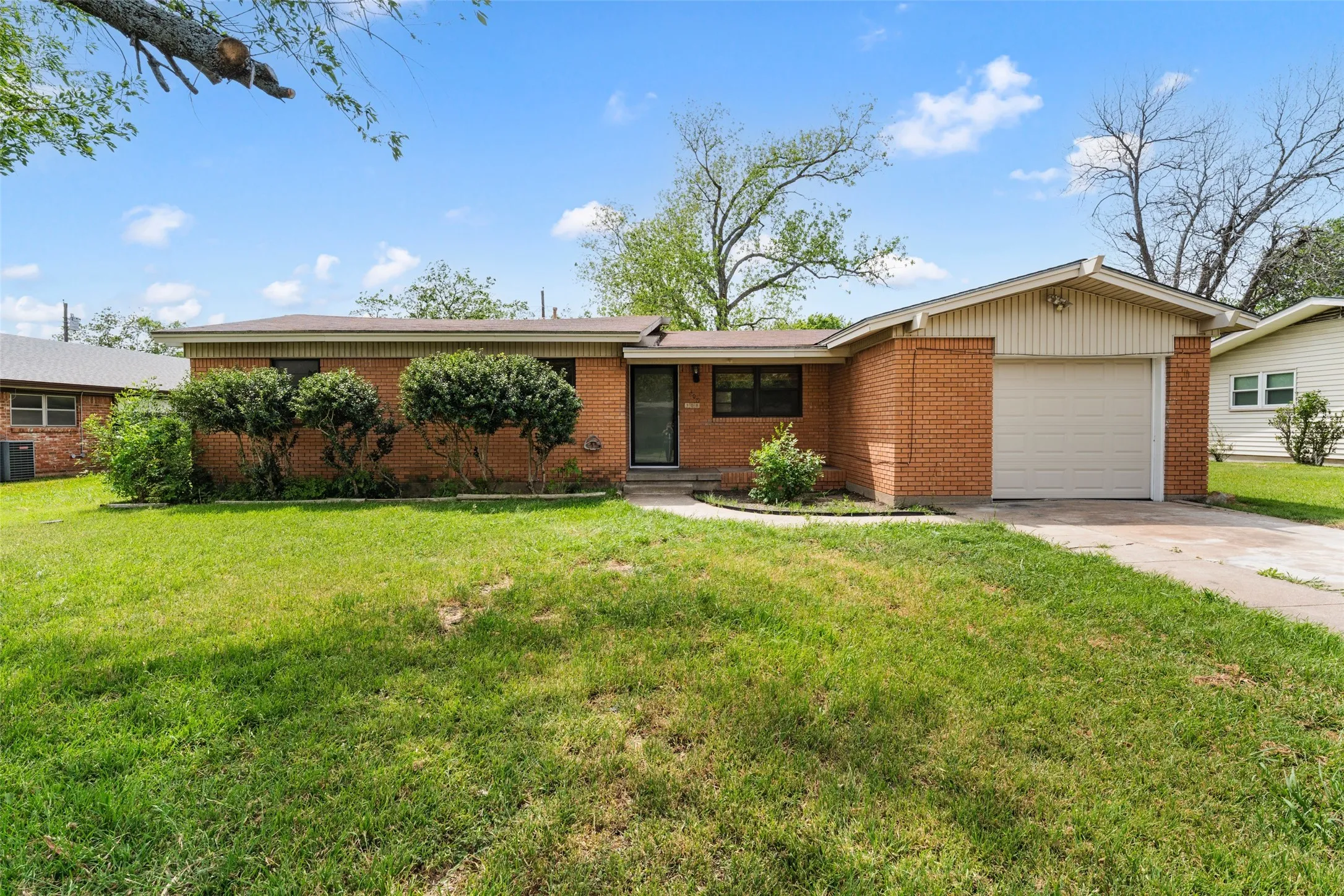 Brick exterior with an attached single-car garage and a paved driveway