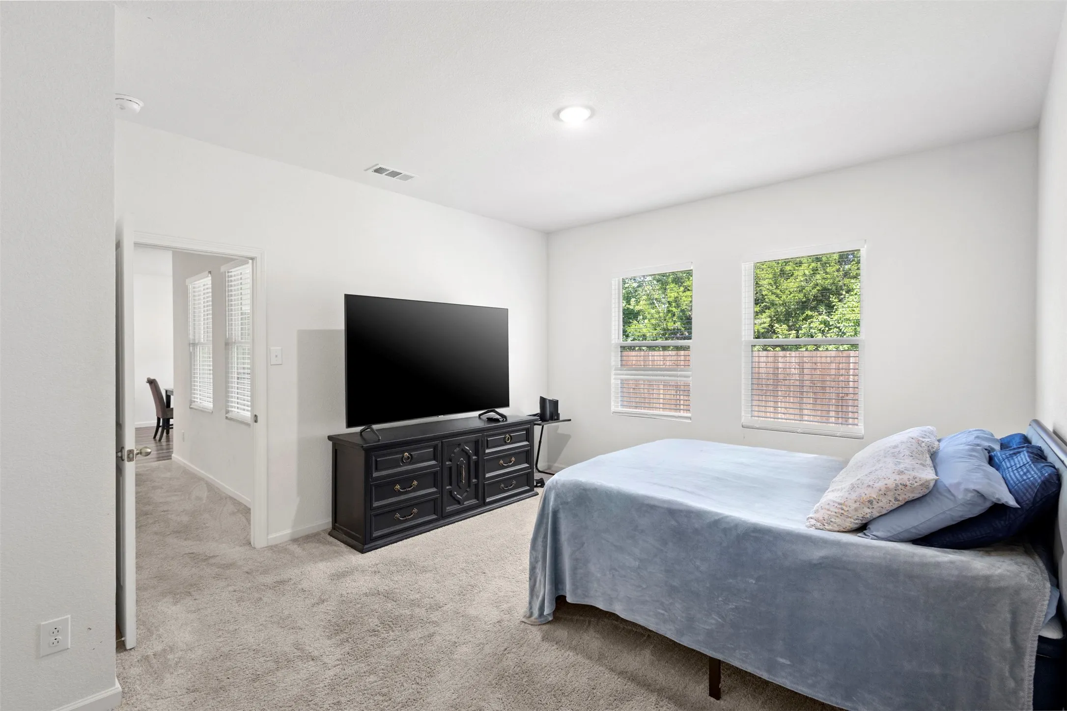 Recessed lighting, light-toned walls, and carpet flooring