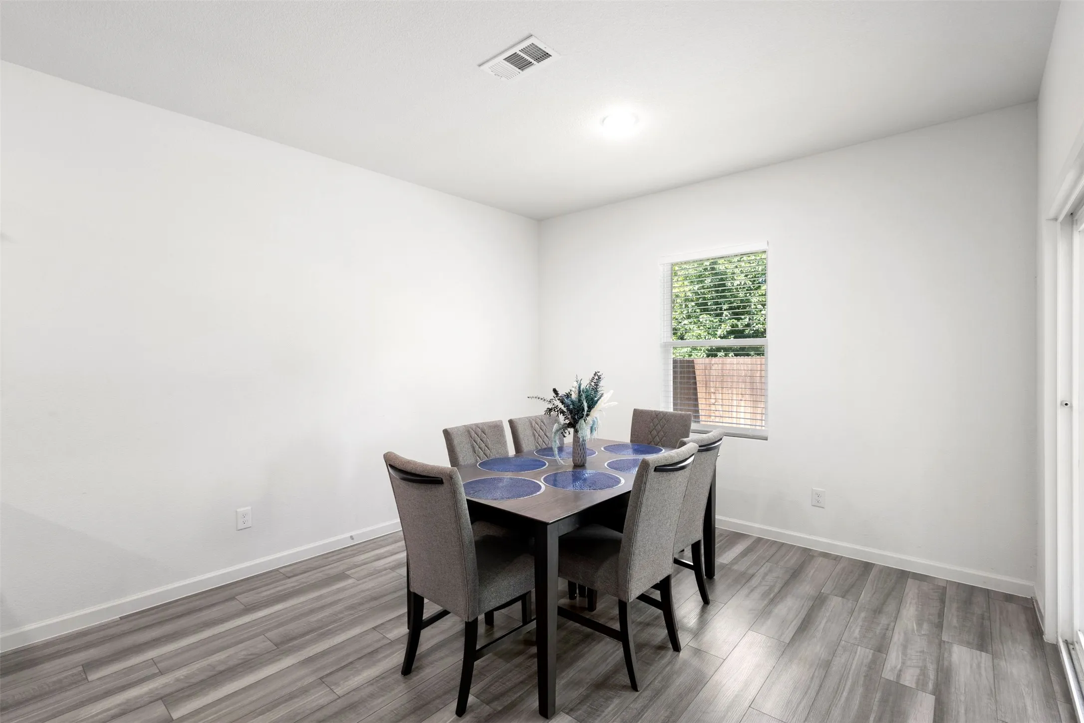 Recessed lighting, wood-finish flooring, and white painted walls