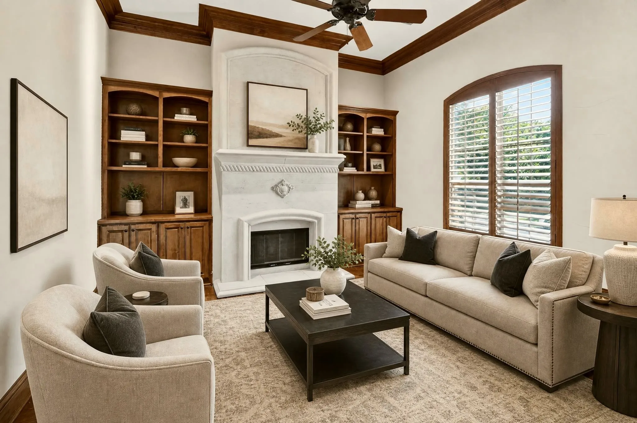 Gorgious front room staged as a formal living. Could be a designated office with built-in shelving, stone fireplace, arched window with wood shutters