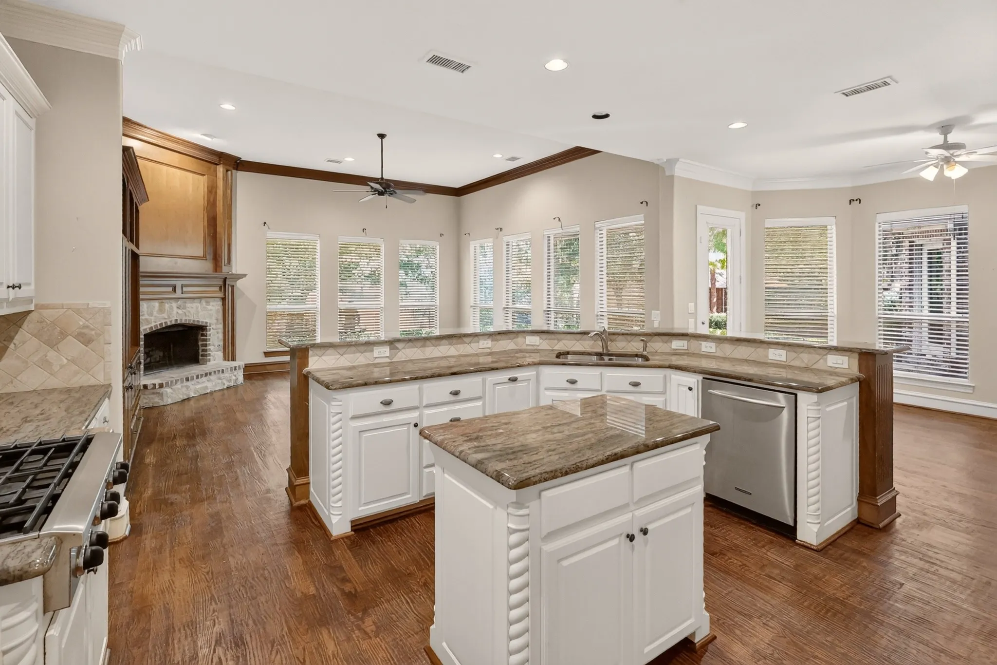 Island kitchen, wood flooring, overlooks family room, breakfast area and water view.