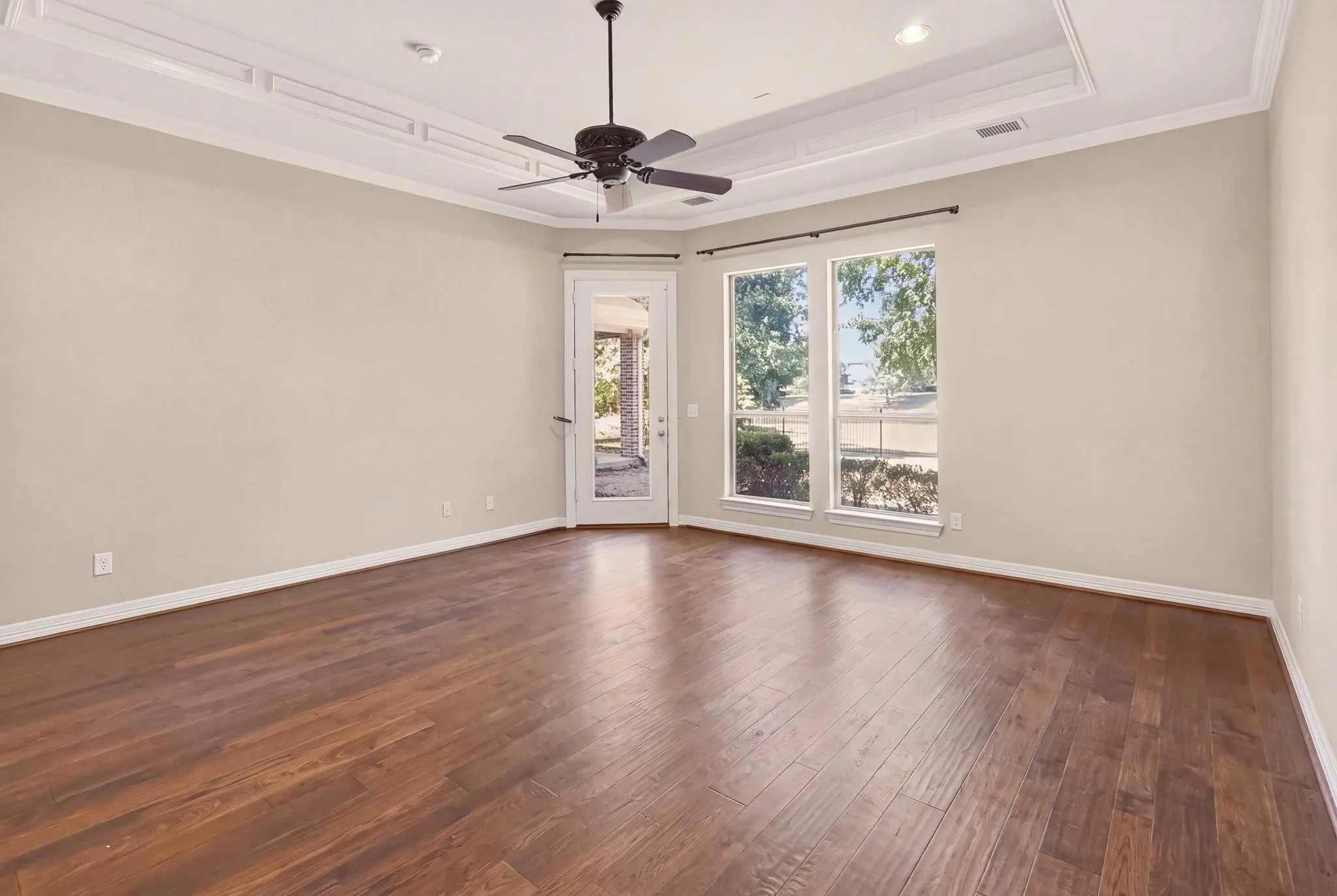 Spacious primary bedroom with water view and patio access.