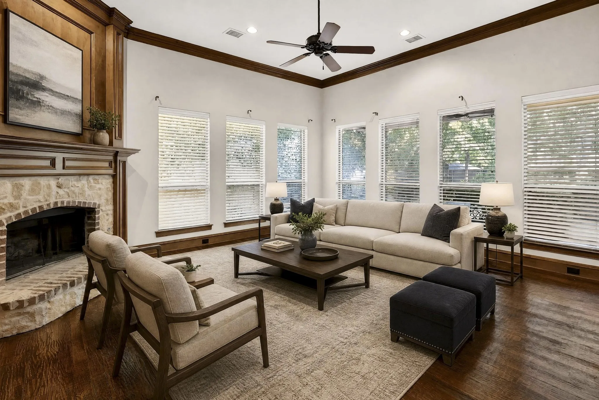Virtually staged family room with second fireplace, wood mantle, recessed lighting, rich wood flooring, and multiple windows with blinds. Gorgeous water views.