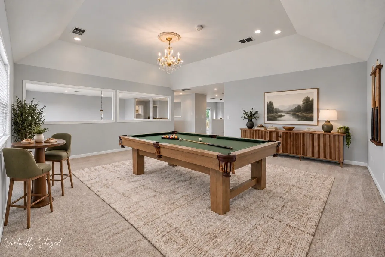 Vaulted ceiling with a central chandelier and recessed lighting