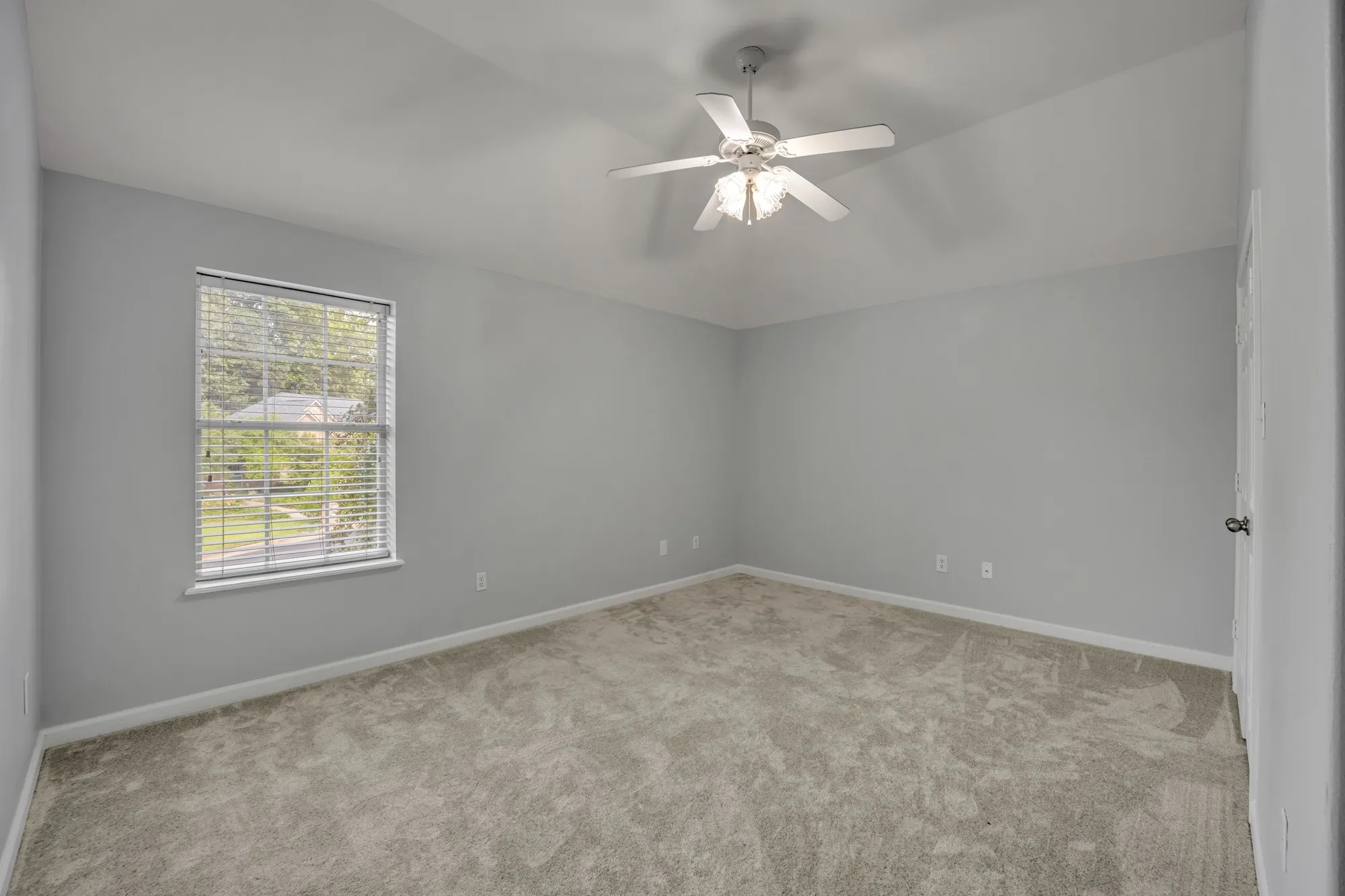 Light gray walls with soft gray carpeting
