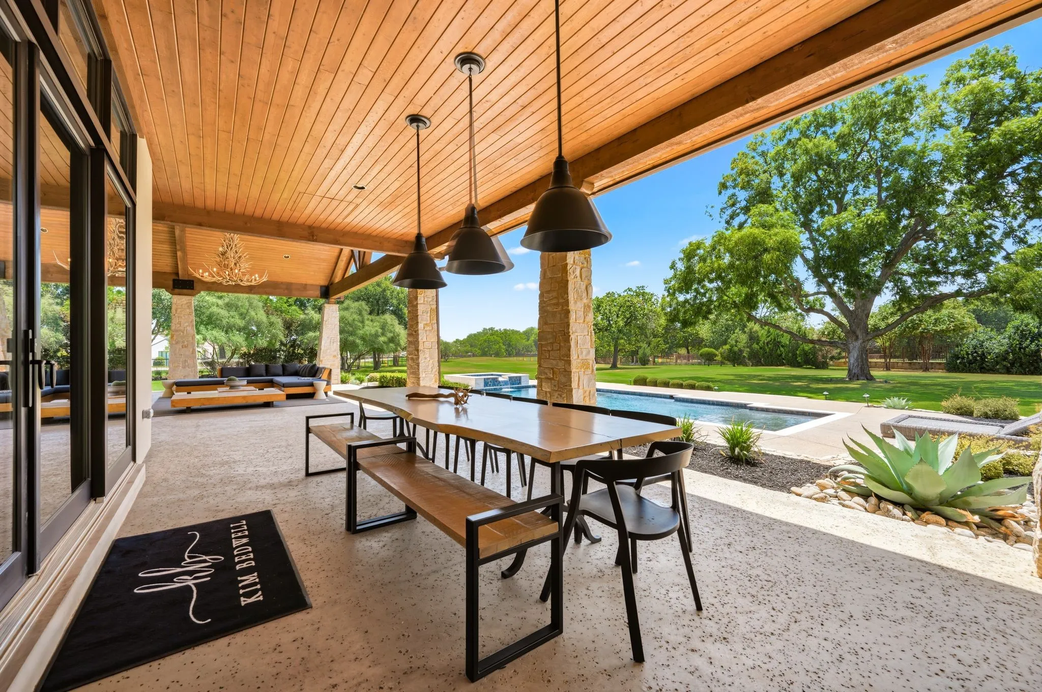 Outdoor dining feels effortless beneath the expansive covered patio.