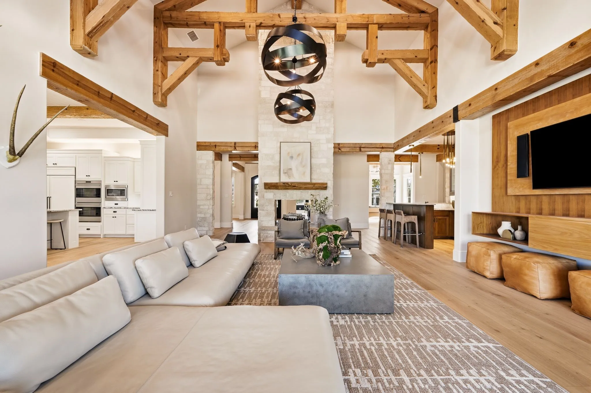 Relaxed luxury with warm architectural details and views outdoors.