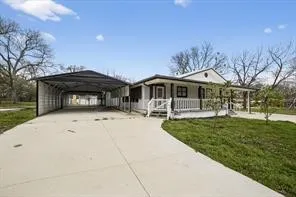 Single-story exterior with a covered porch, white railing, and a gabled roofline
