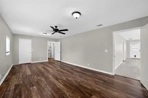 Spacious room featuring wood-finish flooring, light gray wall paint, a ceiling fan, and recessed lighting fixtures