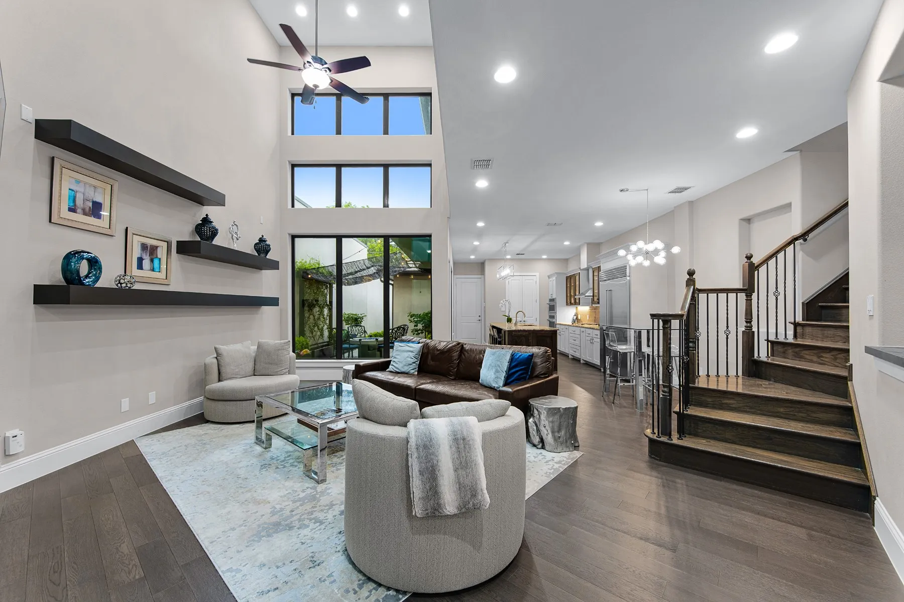 Two-Story Living Room opens to Kitchen Patio and Firepit