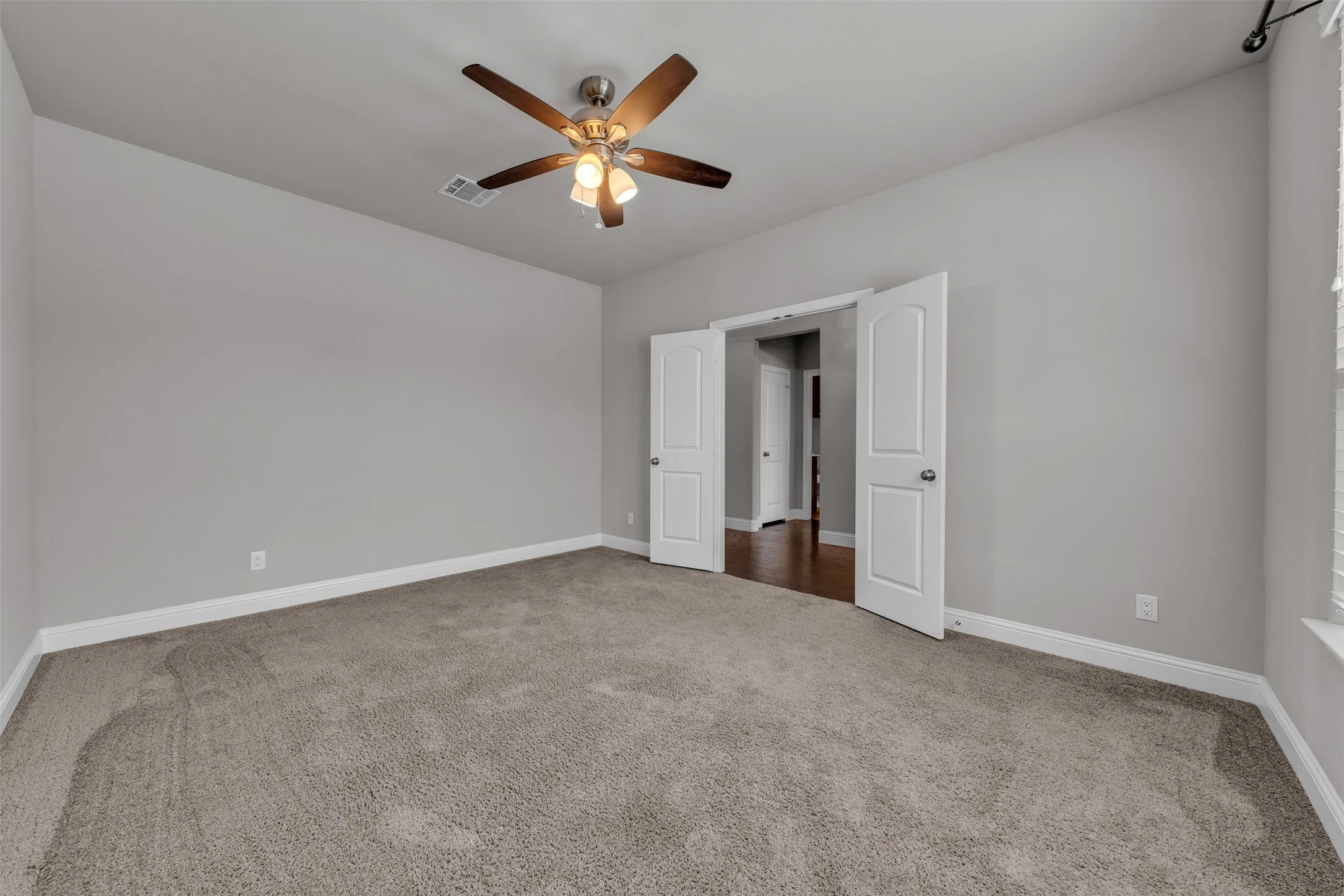 Neutral-toned walls, vaulted ceiling, and plush carpeting