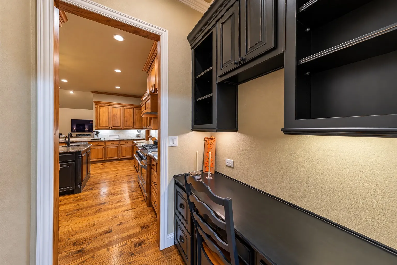 A built-in desk with cabinets is located just off of the kitchen and adjacent to the laundry room.