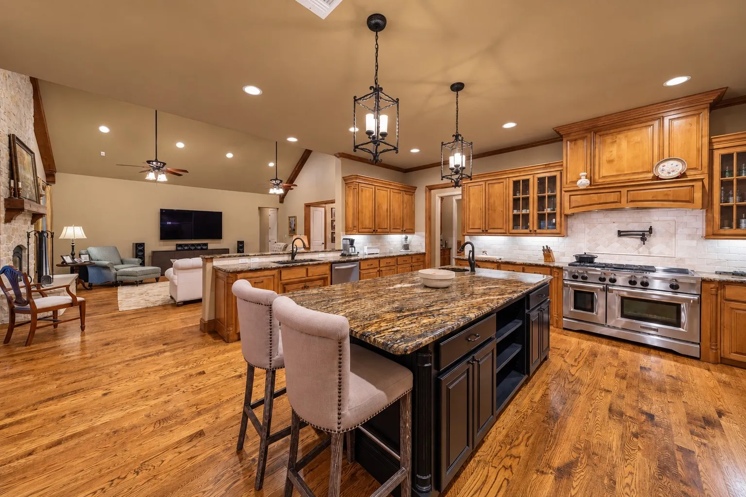 The kitchen features a commercial grade range with a gas cooktop, electric oven and pot filler mounted to the wall.