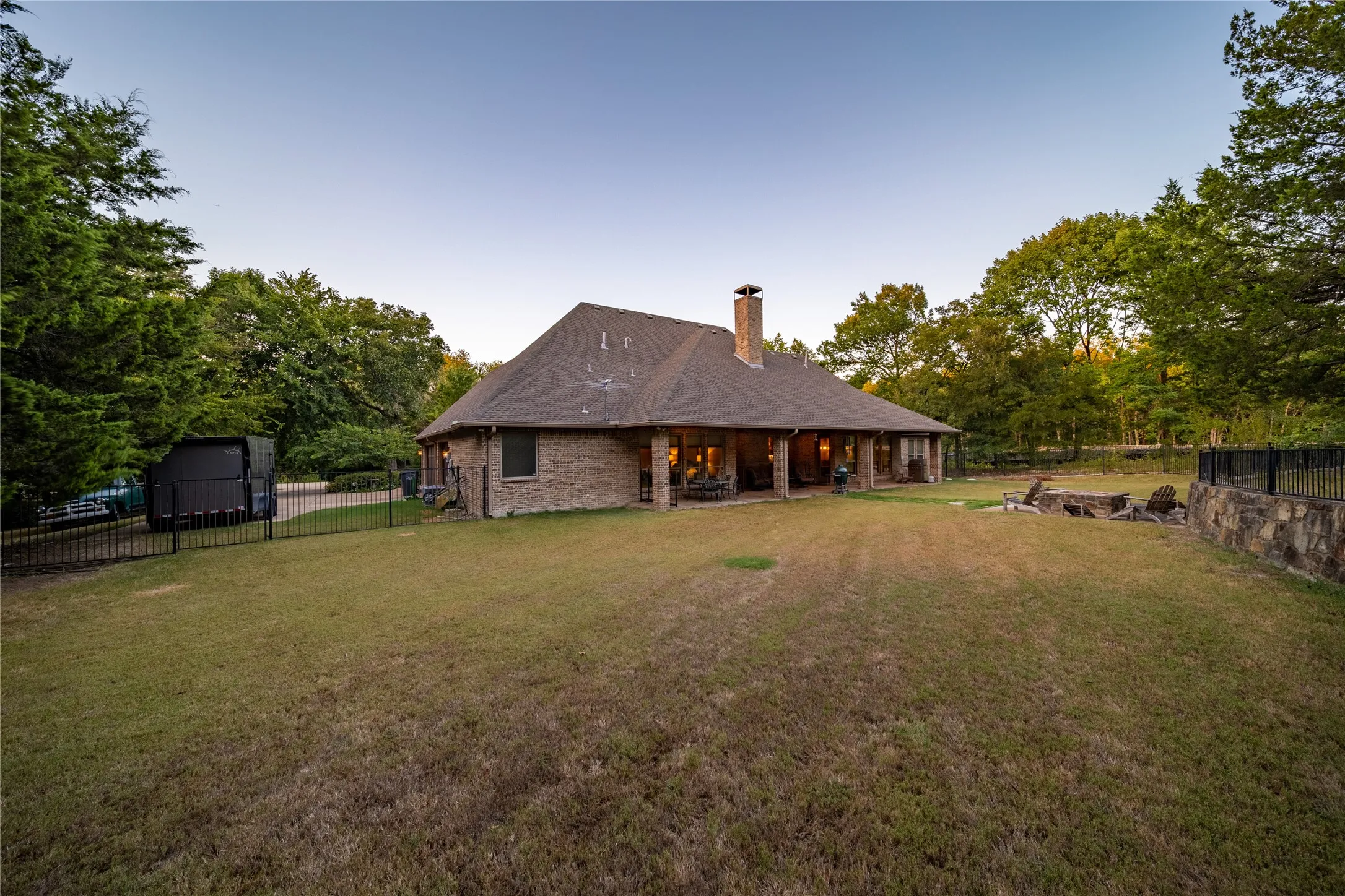 Looking into the back yard from the South West corner of the property.  The driveway is located to the left in the photo.