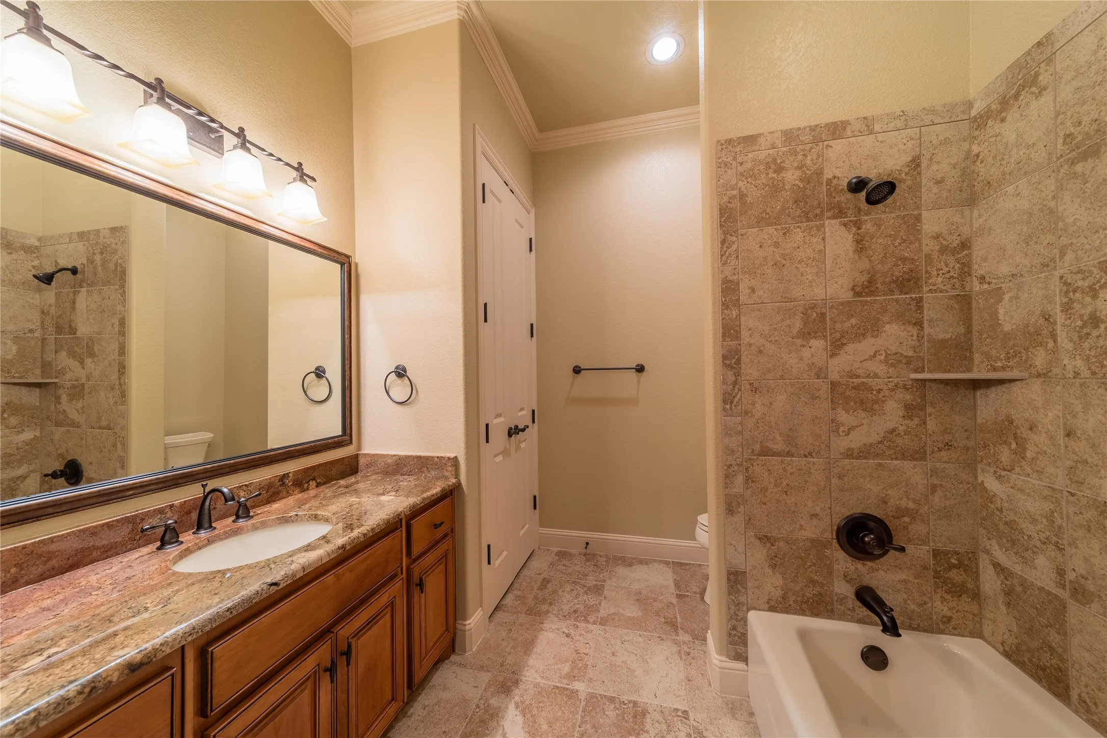 The second bathroom is located within the second bedroom and features a large linen closet.