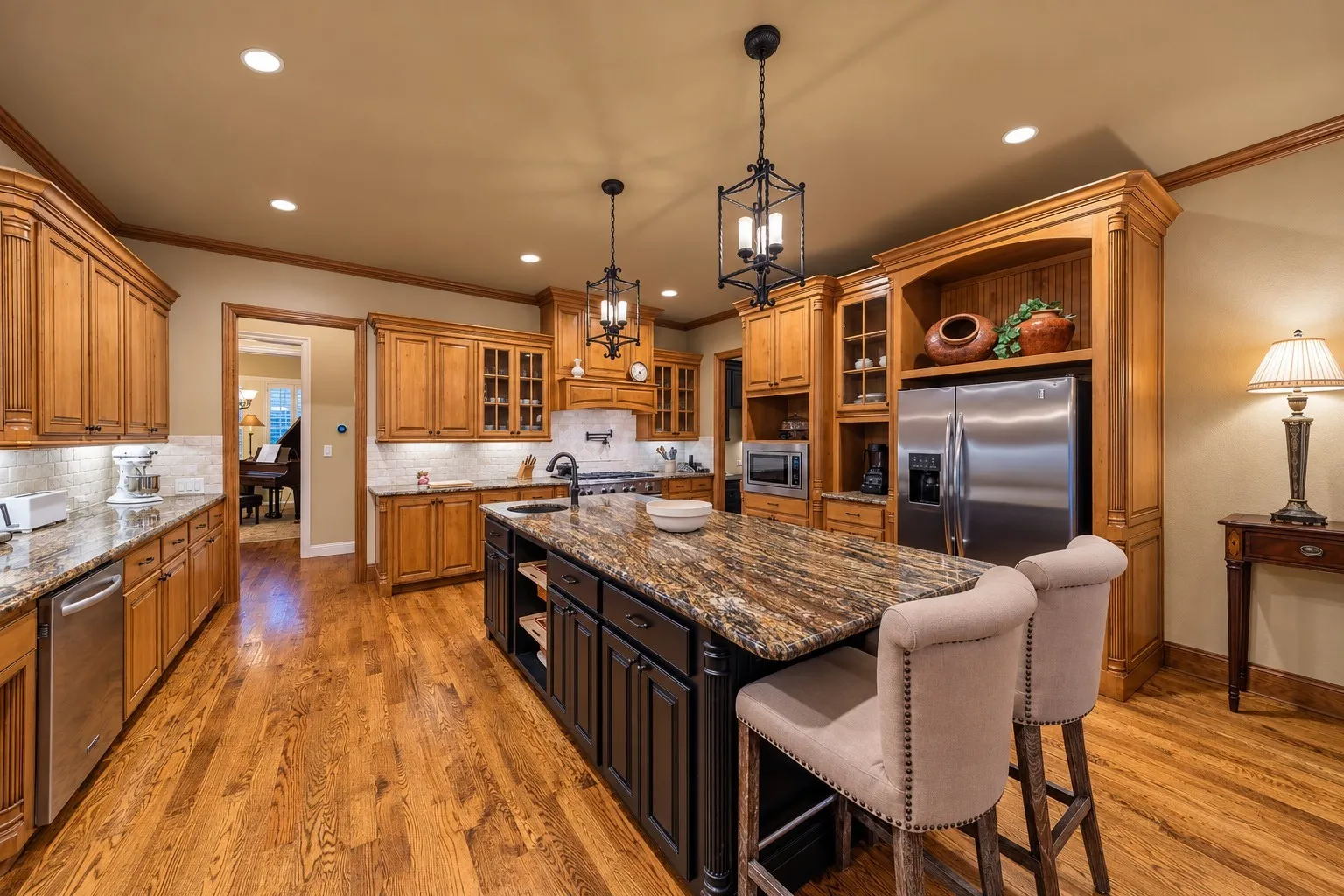 The spacious kitchen connects to the formal dining room, which is where the piano is located.