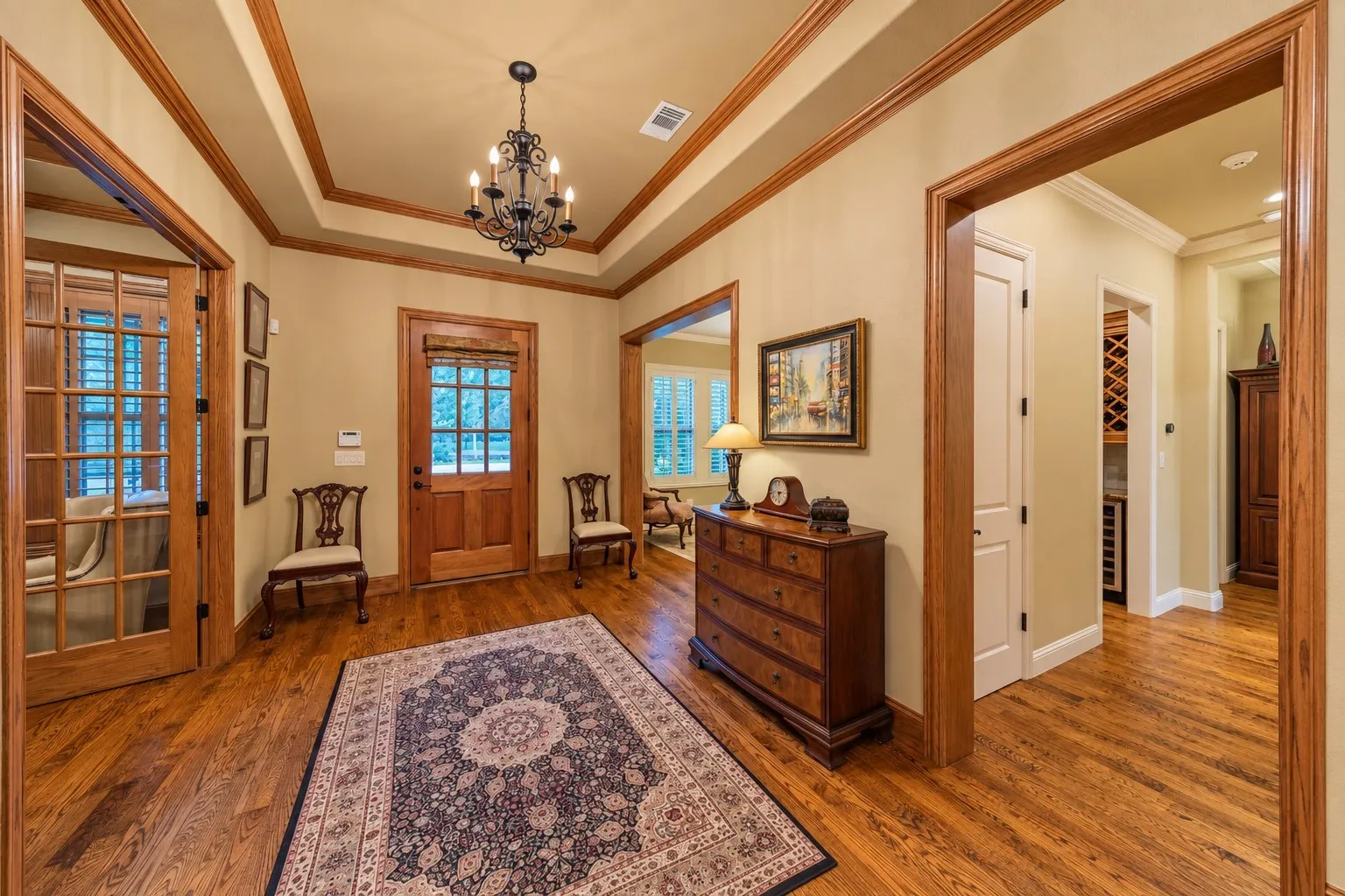 The front door to the home is located in the center of the photo. The door to the left of the front door is the office. the door to the right of the front door in the photo is the formal dining room.