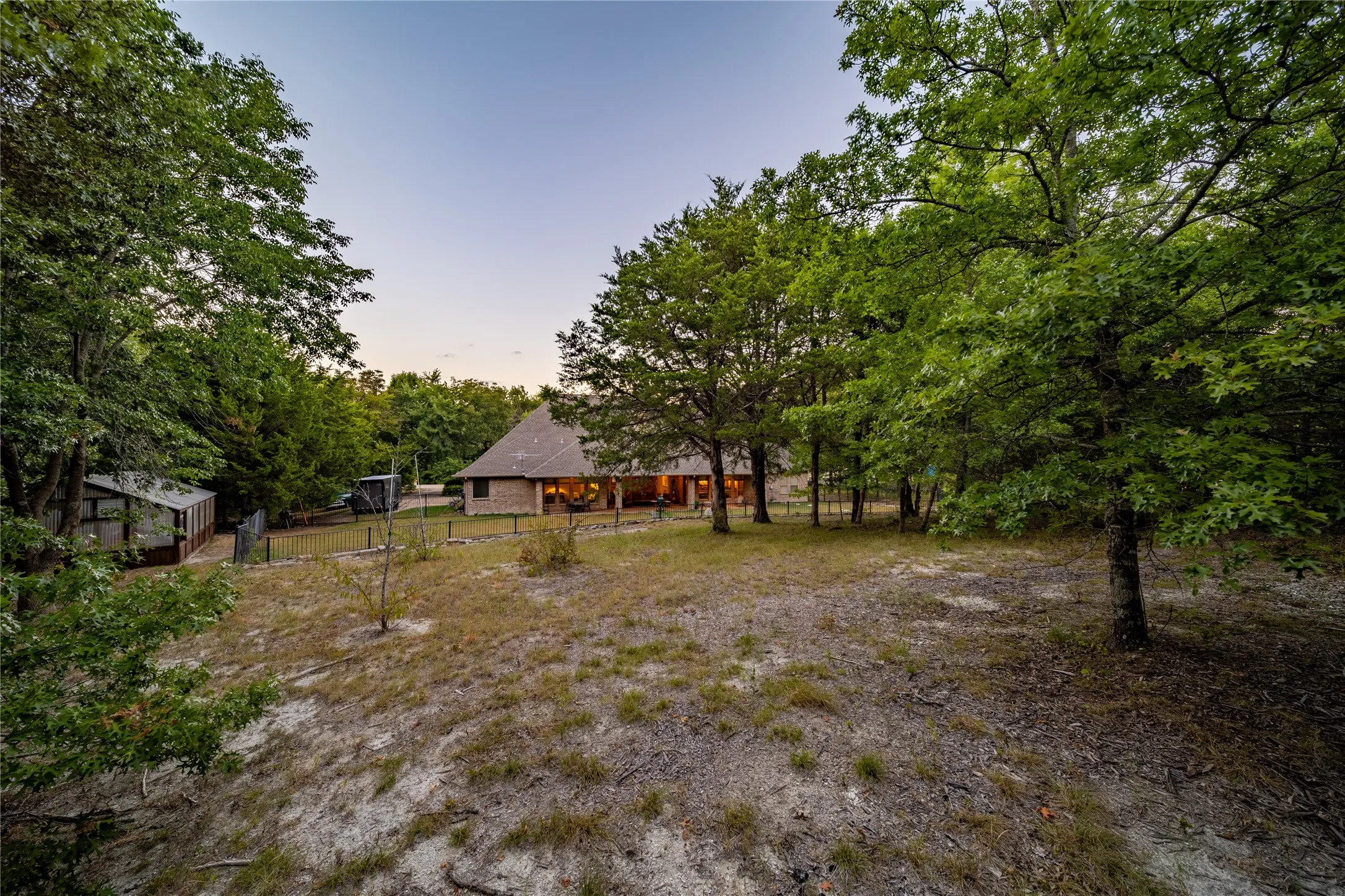 The upper level of the back yard is where the wooded portion of the lot is located.