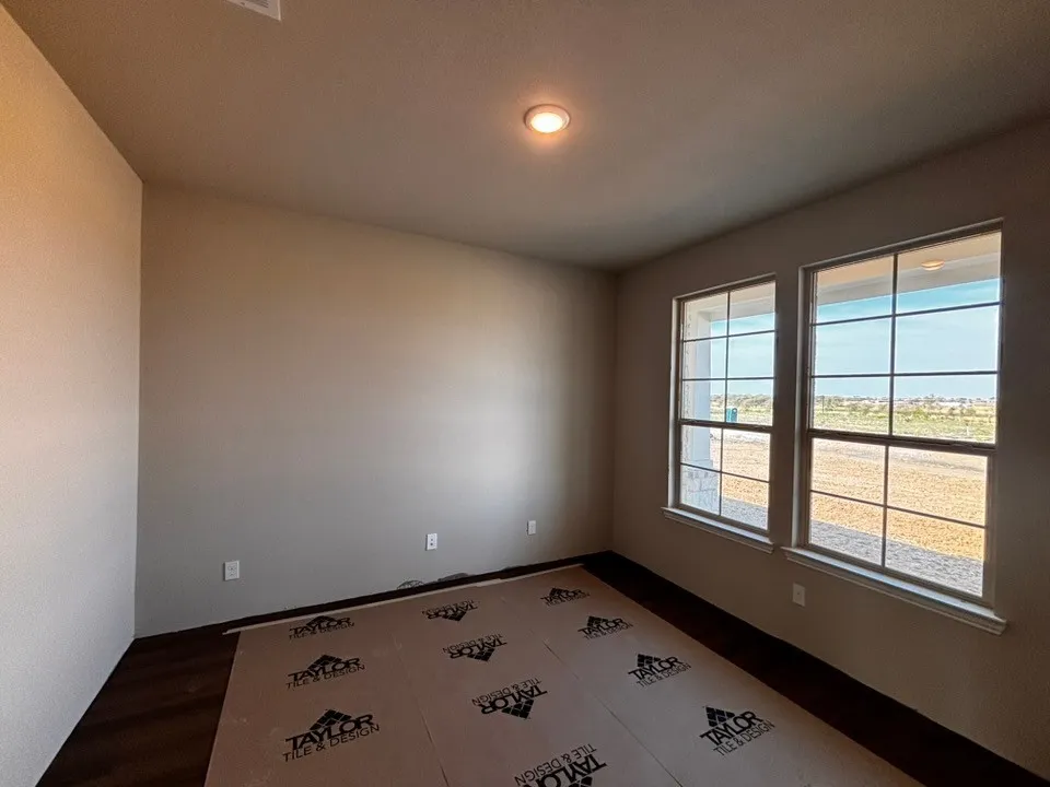 Dual window placement, recessed ceiling lighting, and wood-finish flooring