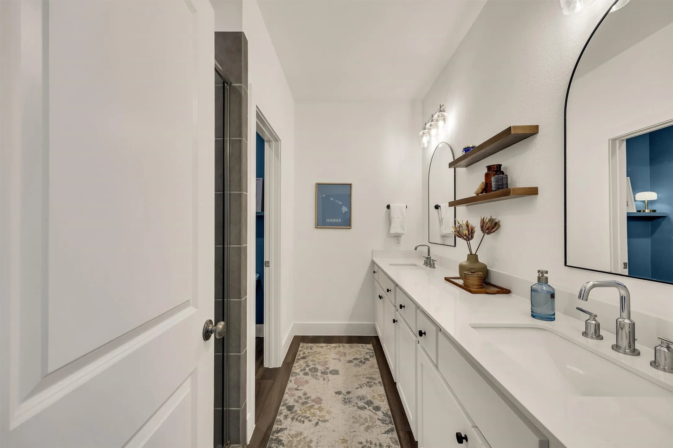 Double vanity with undermount sinks, chrome faucets, and white countertop