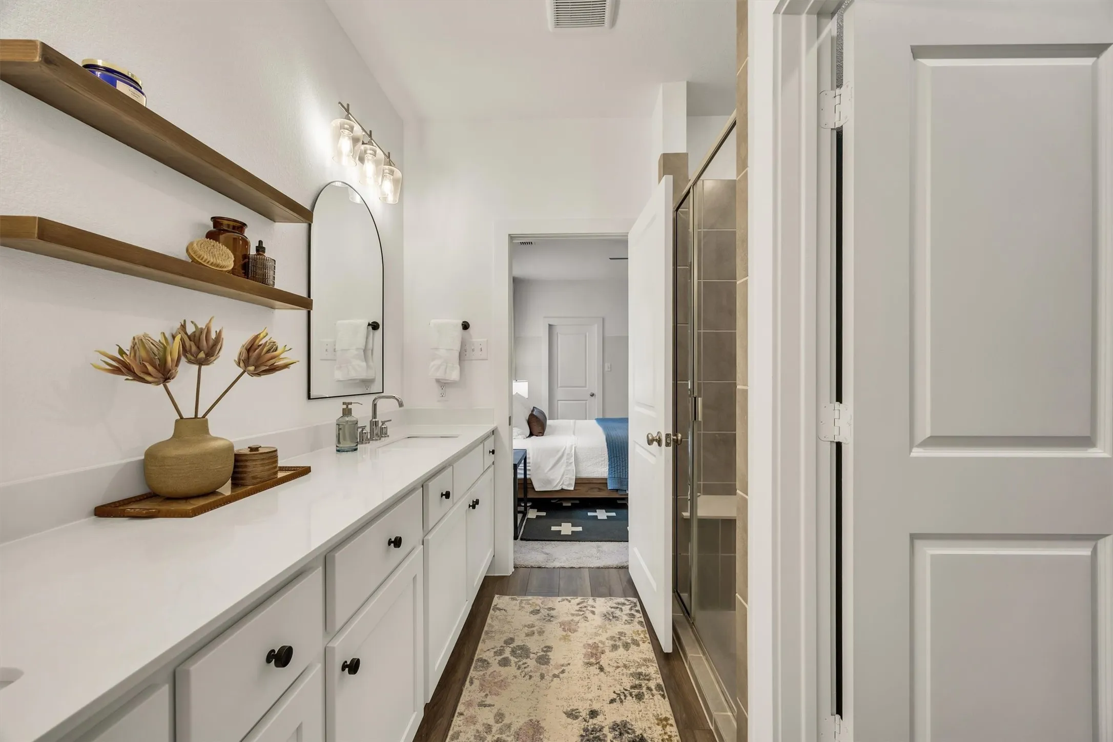 Extended vanity with white countertop, undermount sink, and matte black hardware