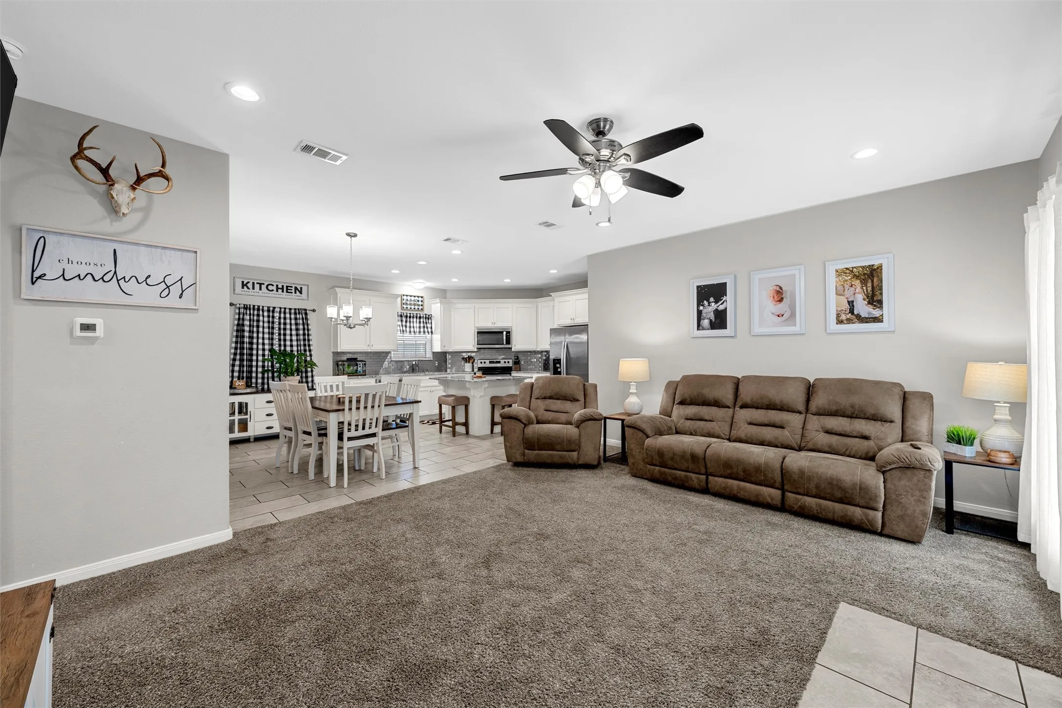Open-concept living space with recessed lighting, a ceiling fan, and carpet flooring