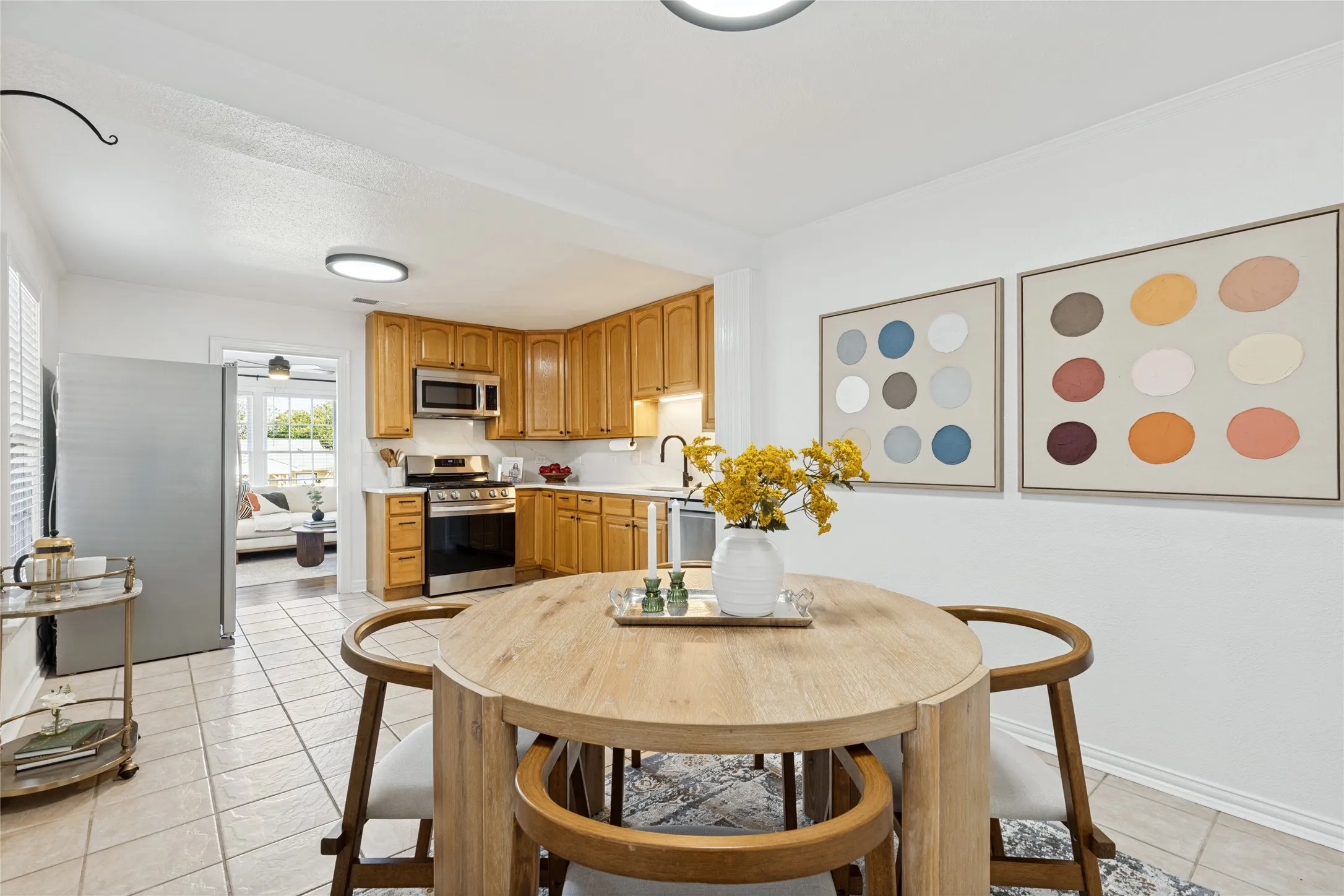 Kitchen with wood cabinetry, stainless steel appliances, and white countertops