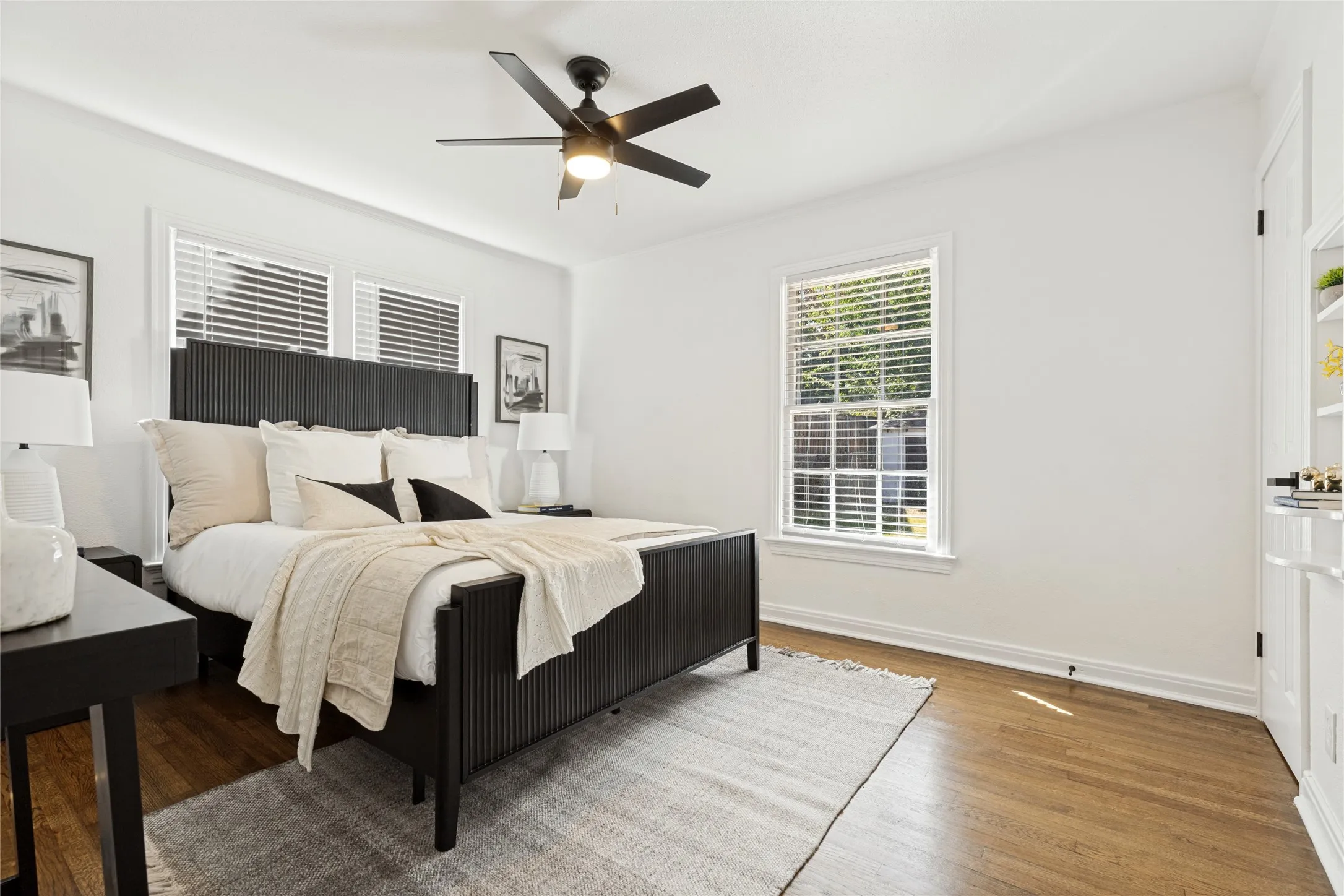 Hardwood flooring, recessed lighting, ceiling fan, multiple windows with blinds, and built-in shelving