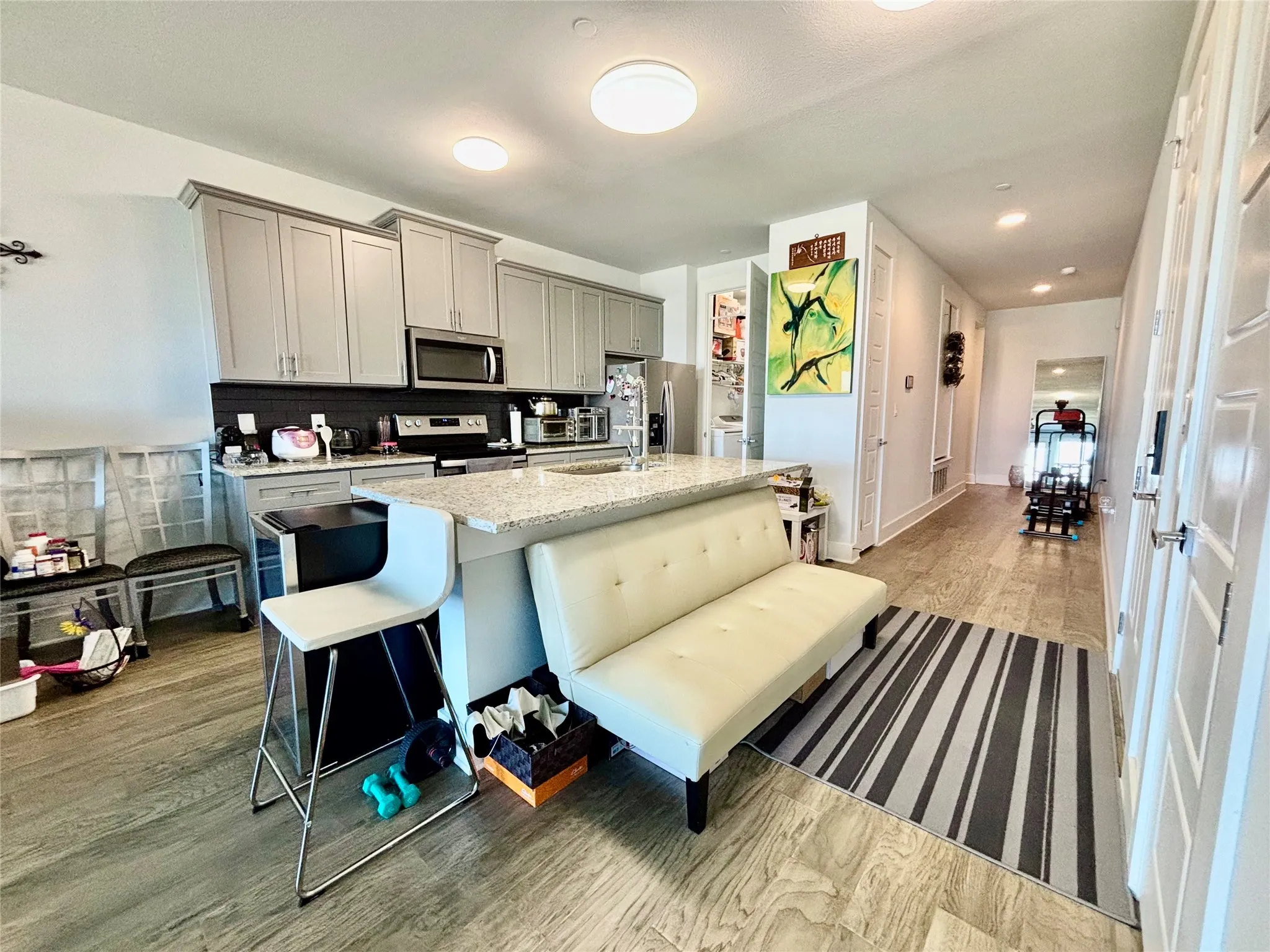 Kitchen with light gray cabinetry, stainless steel appliances, and a light-toned countertop